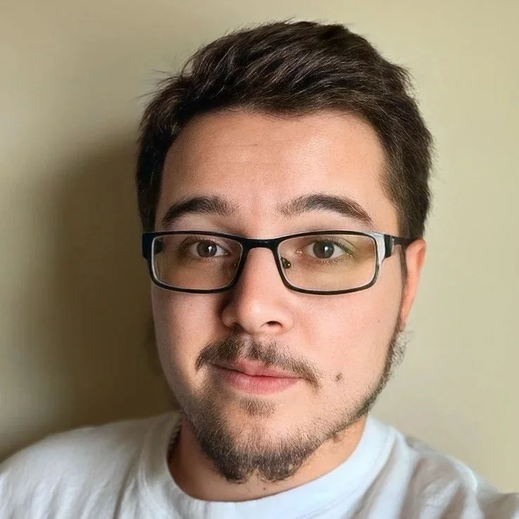 male wearing glasses with brown hair
