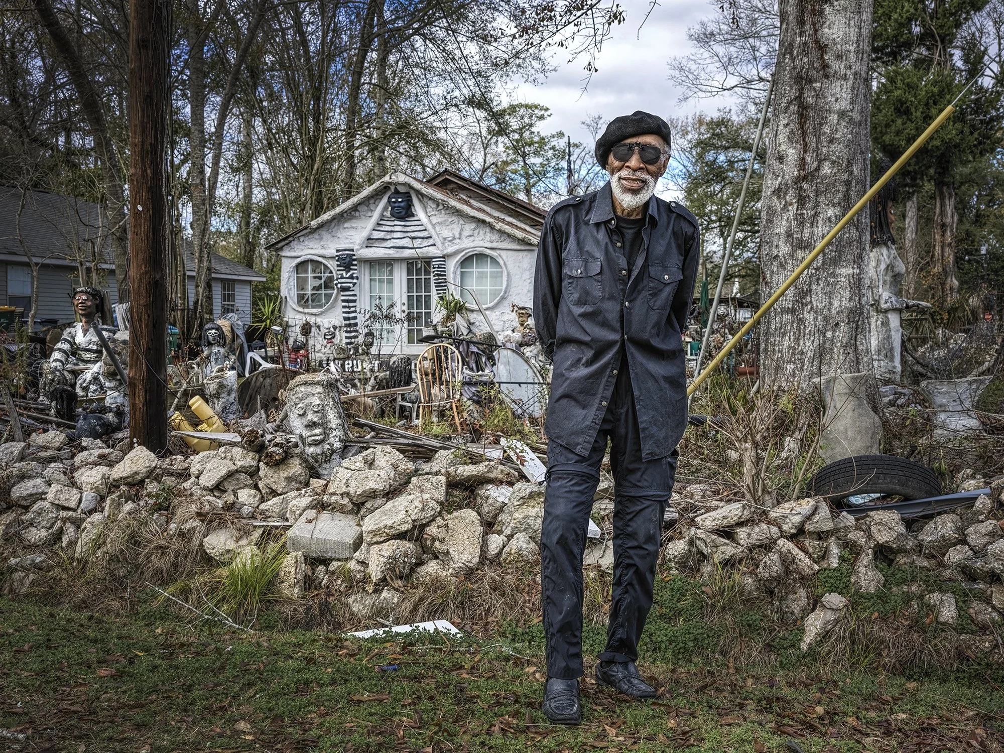 Dr. Charles Smith standing in front of his former home and museum, ravaged by Hurricane Ida. Hammond, Louisiana. 2023. 