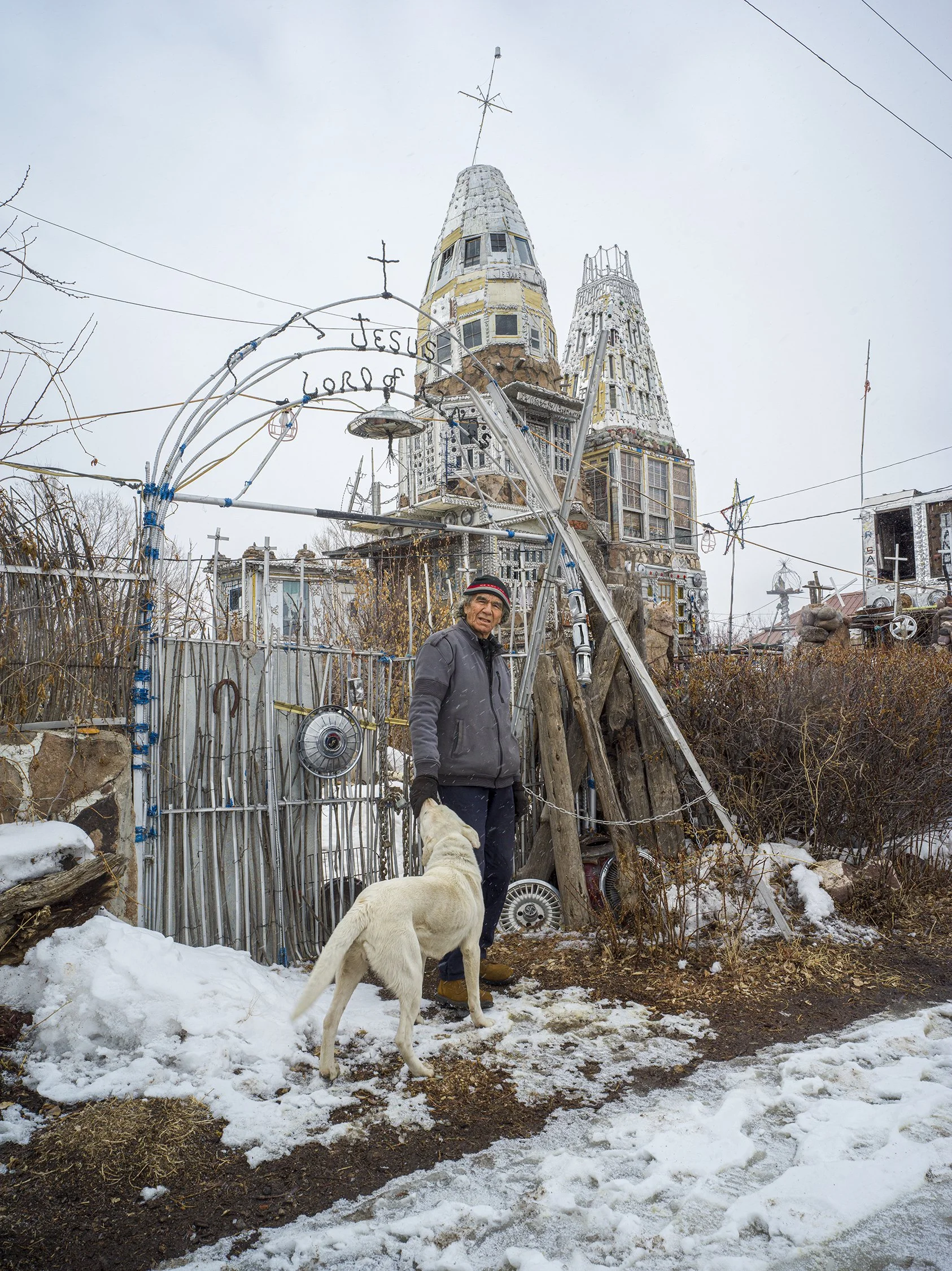 Dominic Cano Espinoza in front of “Cano’s Castle,” the home he built with inspiration from Buddhist temples he saw while serving in Vietnam. Antonito, Colorado. 2020.