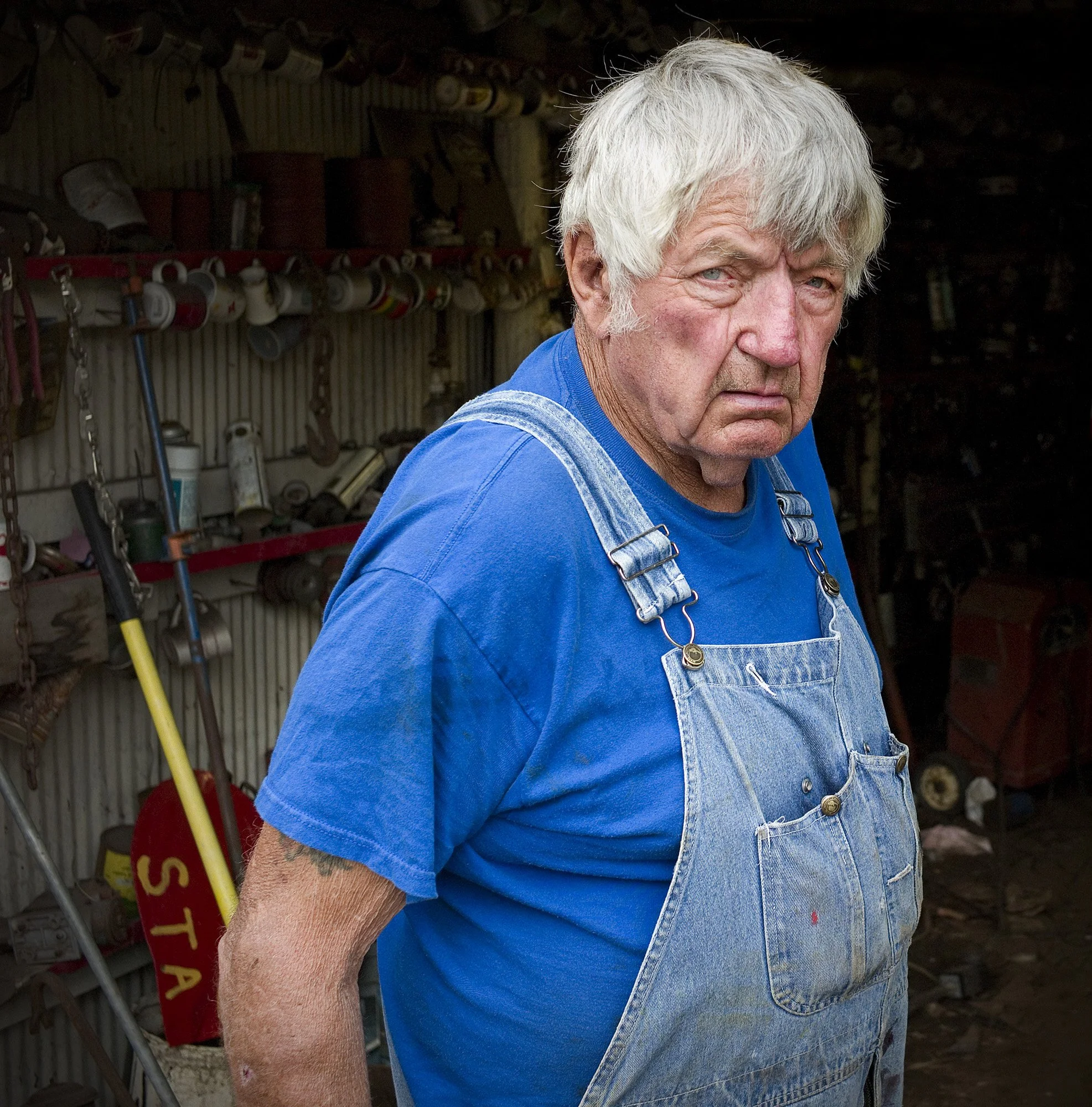 M.T. Liggett casts a skeptical look in his workshop. Mullinville, Kansas. 2010.