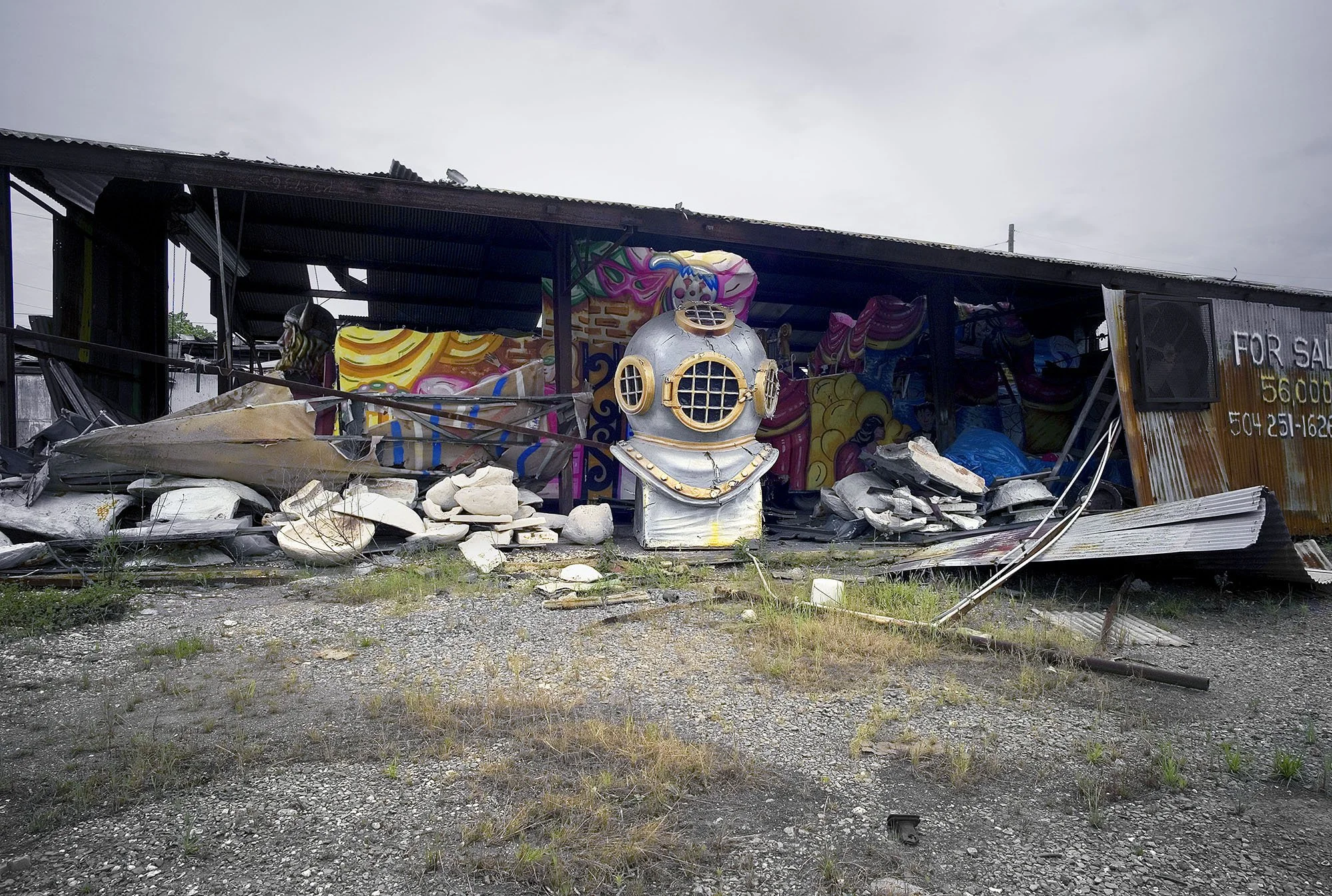 Diver’s helmet, recalling Hurricane Katrina, stored among Mardi Gras parade floats. New Orleans, Louisiana. 2007.