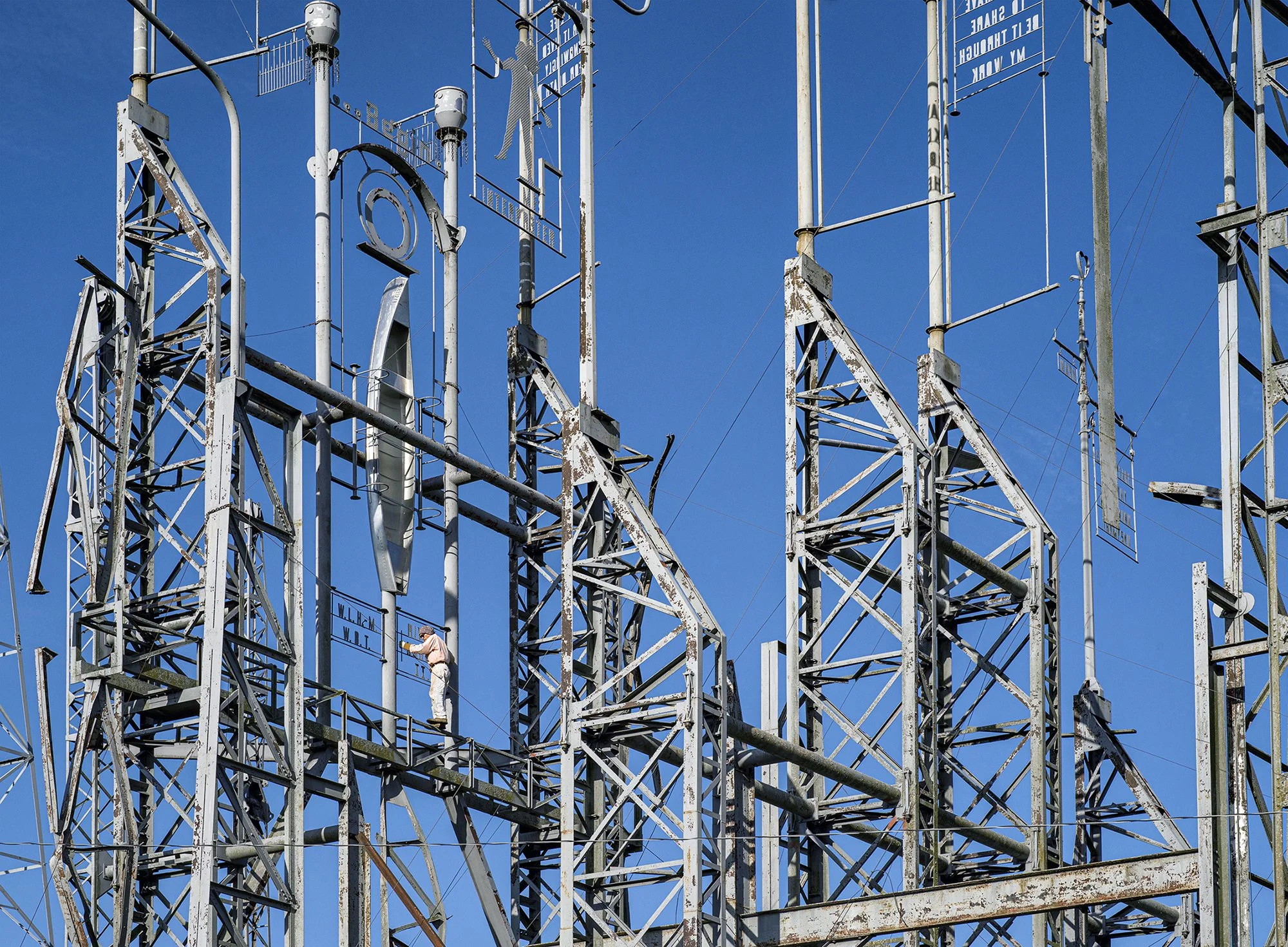 Billy Tripp climbing in his Mindfield, the largest work of art in Tennessee. Brownsville, Tennessee. 2021.