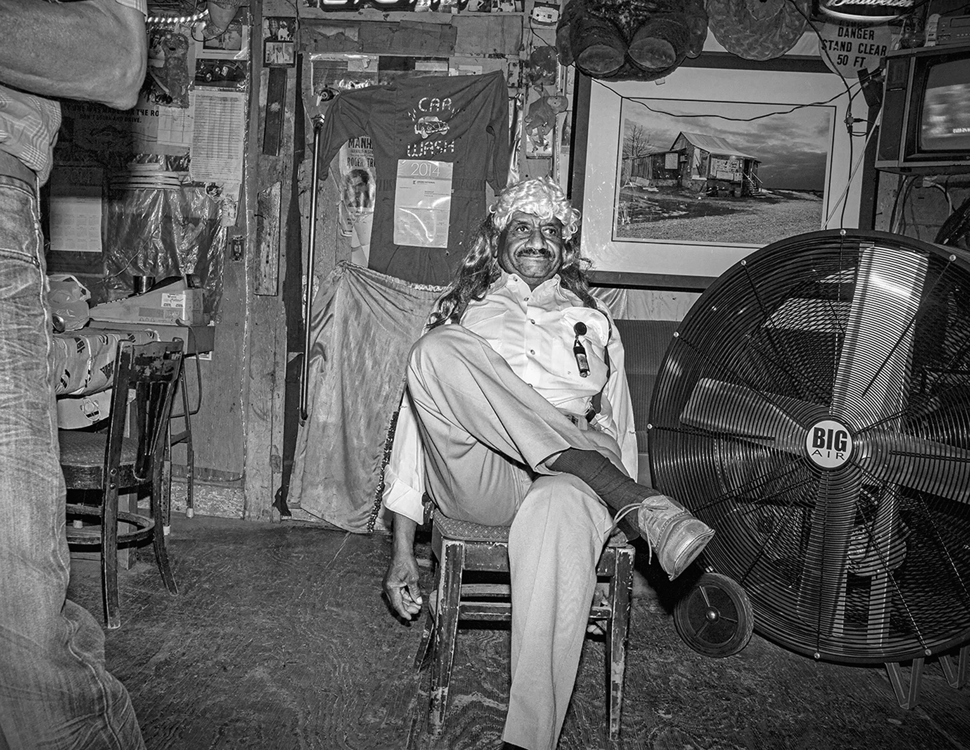 Willie “Poor Monkey” Seaberry donning a wig and relaxing in his juke joint, Poor Monkey’s. Merigold. Mississippi. 2015.