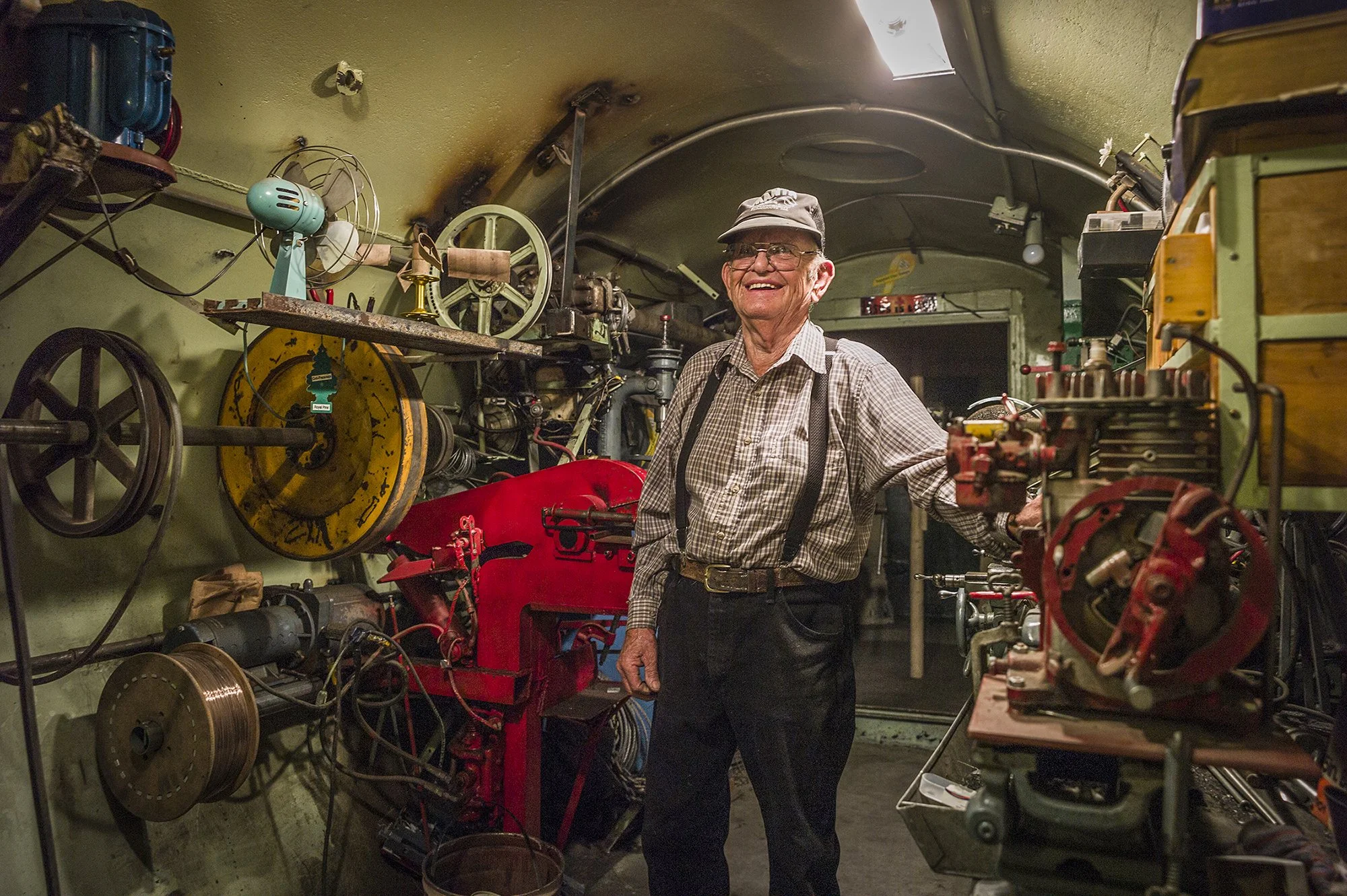 Mel Gould standing in his workshop built from a horizontal silo buried 20 feet beneath the ground. East of Cheyenne, Wyoming. 2014.
