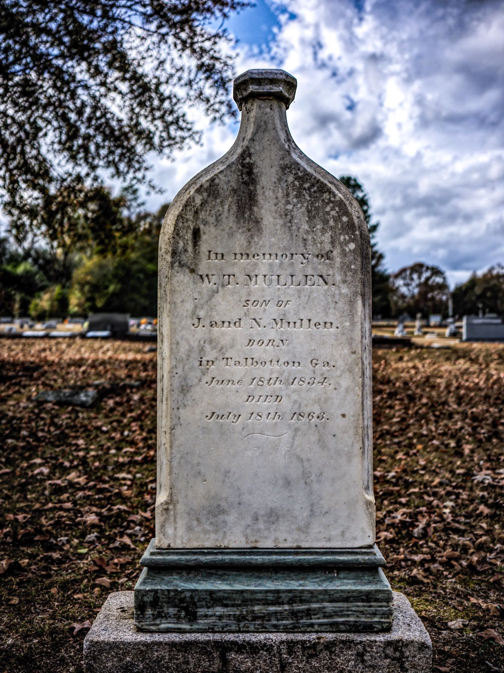 W. T. Mullen’s tombstone in the shape of a liquor bottle. Clayton, Alabama. 2024.