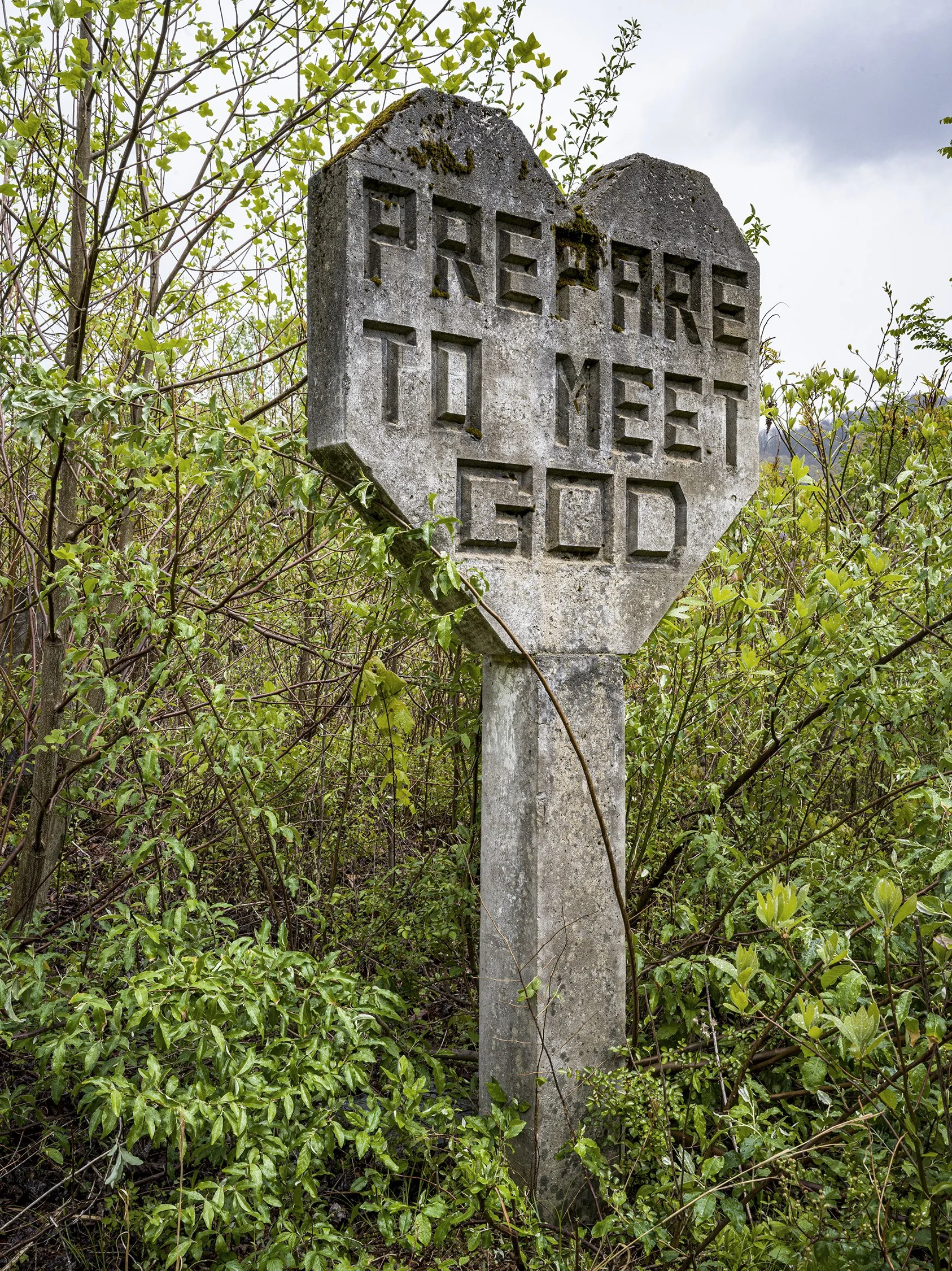 Concrete sign, one of hundreds created by Harrison Mayes. Outside Middlesboro, Kentucky. 2020.