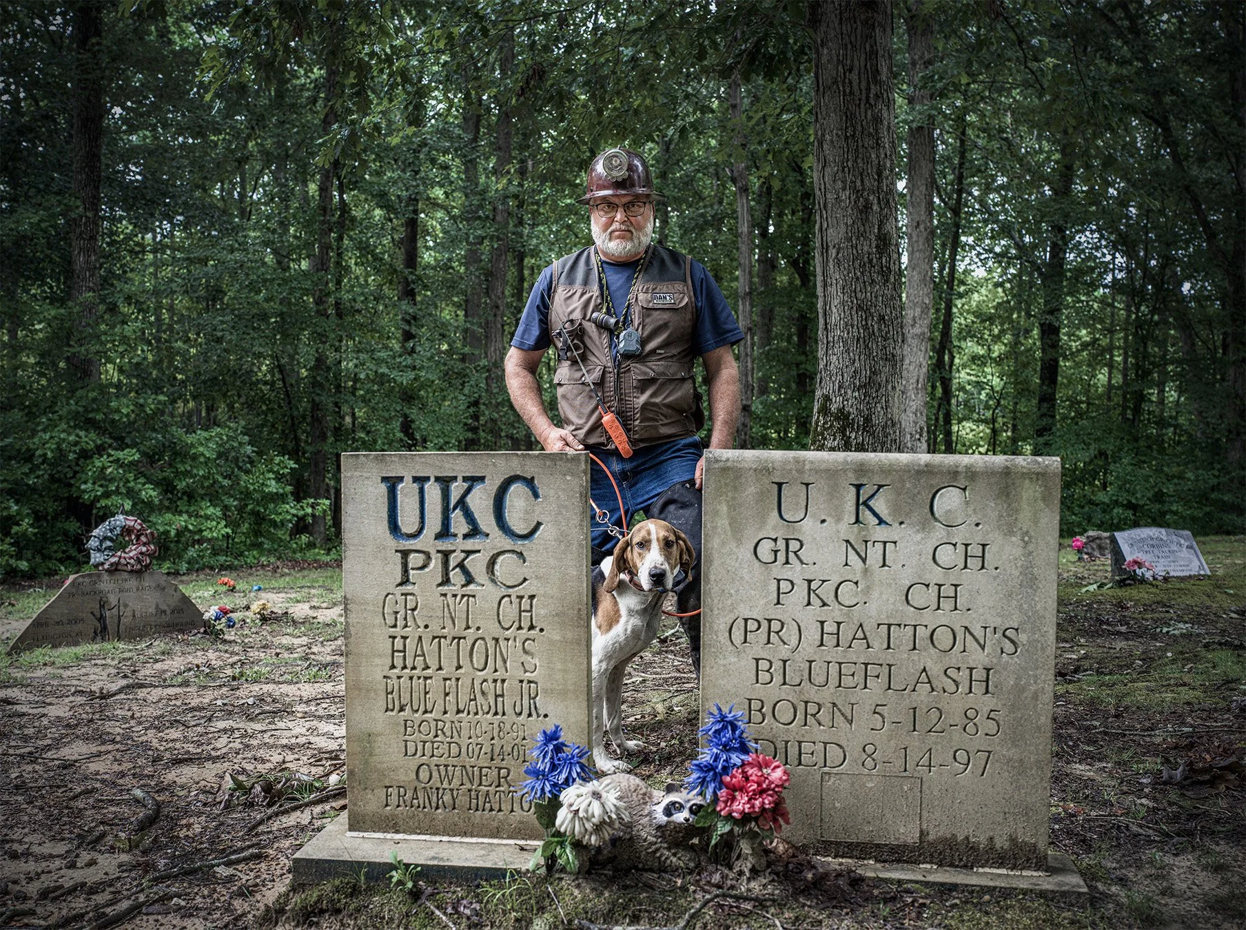 Frankie Hatton, with one of his prize coonhound dogs, Coon Dog Cemetery, near Cherokee, Alabama. 2023.