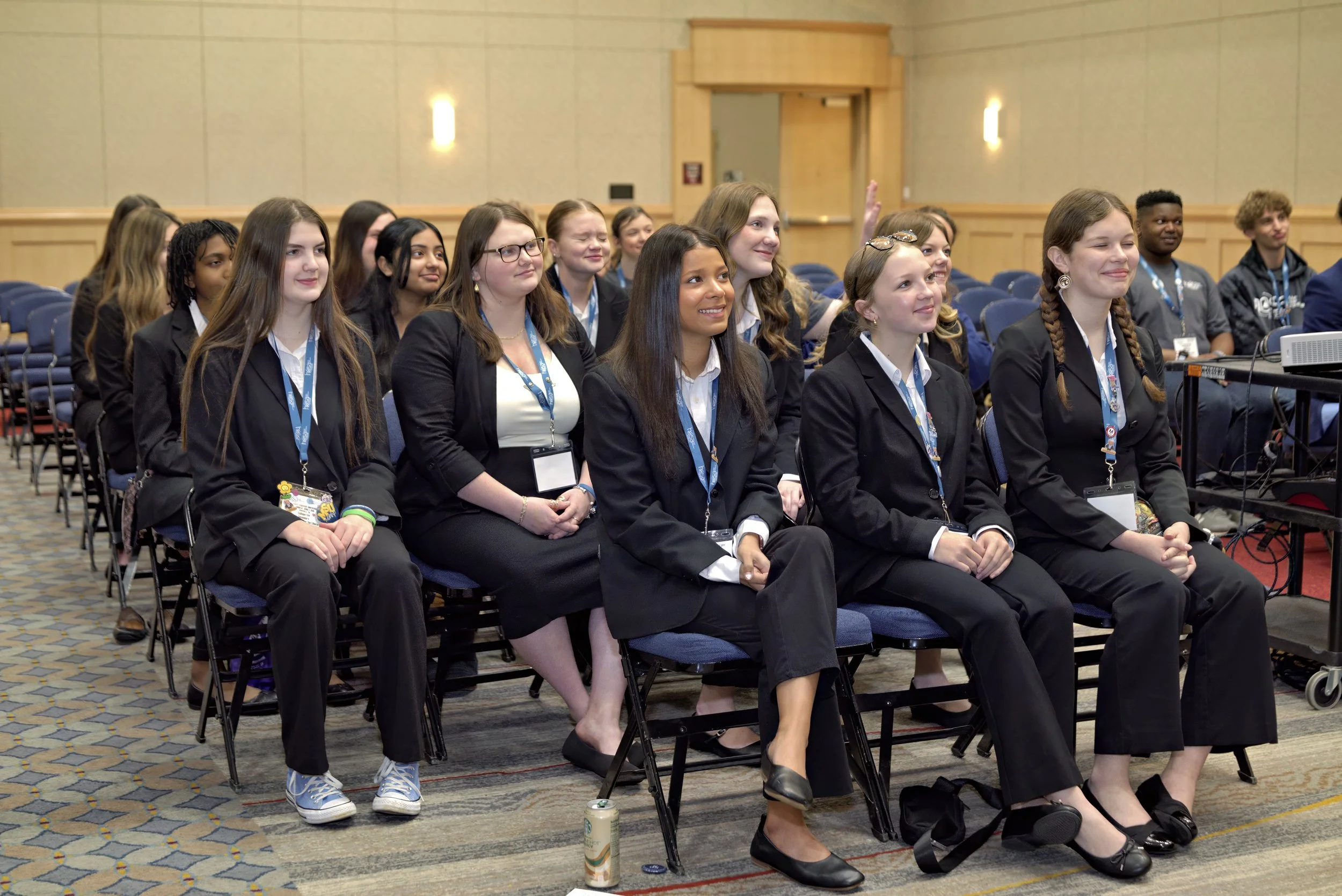 An audience of HOSA members is actively engaged and listening to a Leadership Academy Session.
