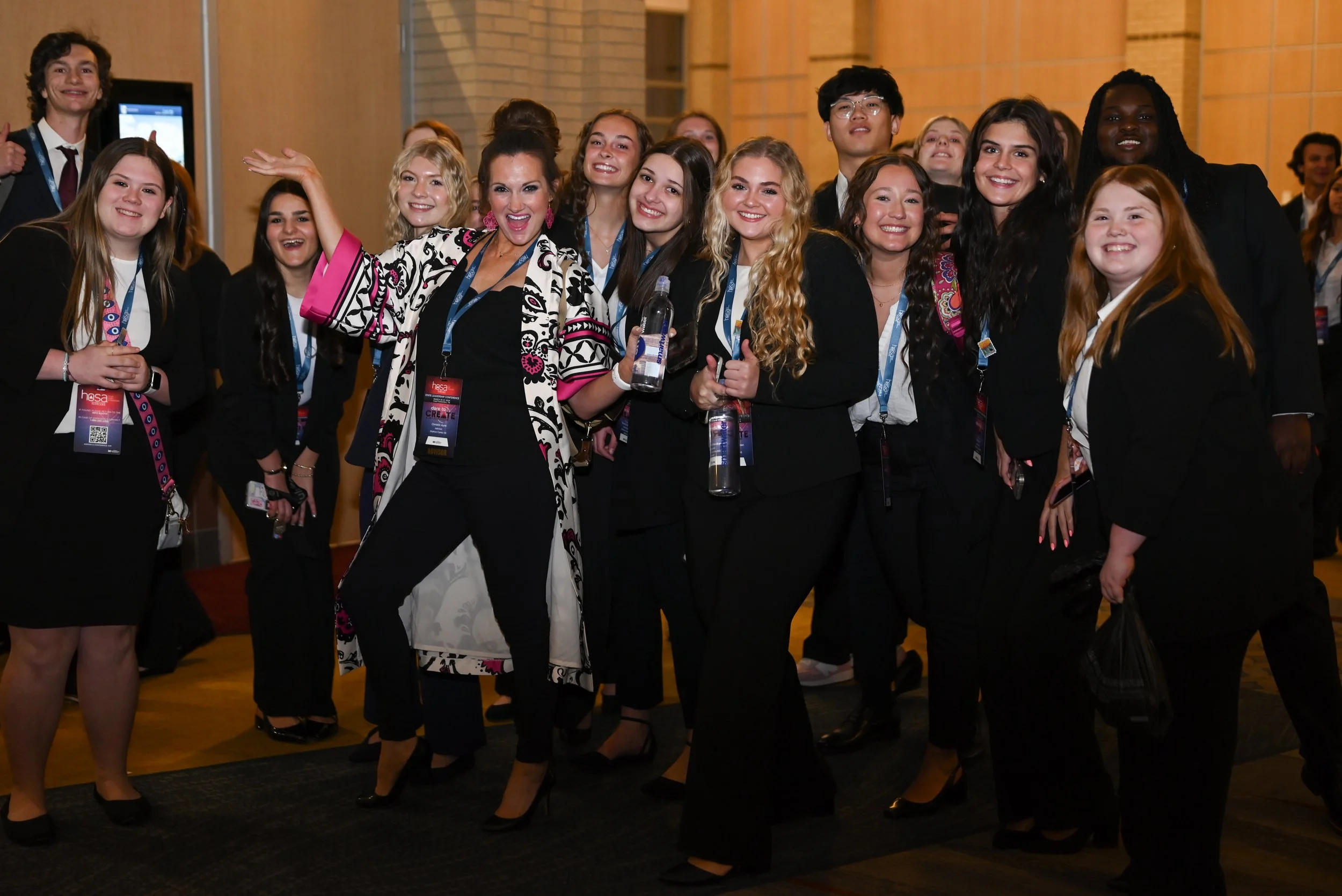 A HOSA advisor celebrates with her students at the State Leadership Conference.