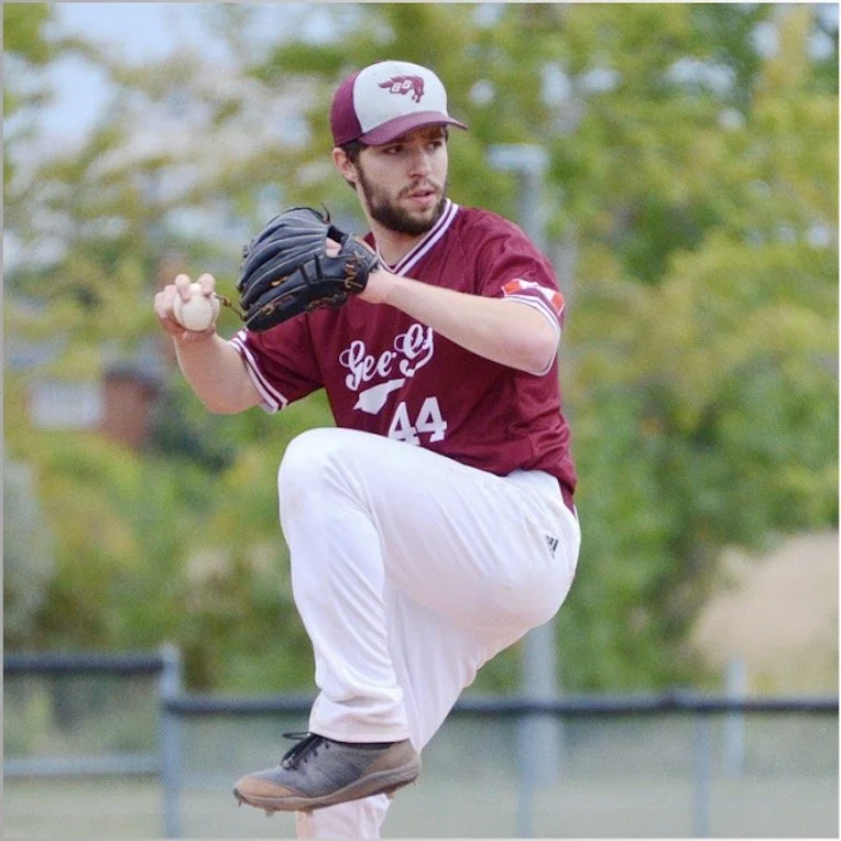 A baseball pitcher in a maroon and white uniform with the number 44 throws a pitch on the field, wearing a baseball glove and cap.