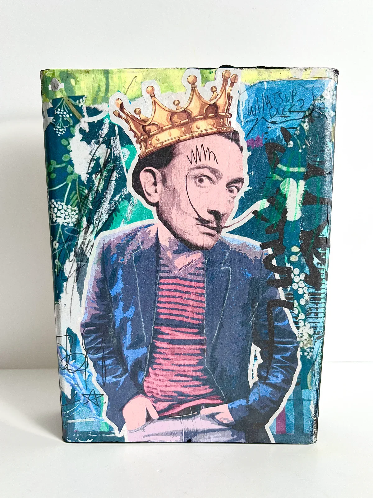 Mixed media collage of a man with a mustache, wearing a crown, a striped shirt, and a jacket, with graffiti and street art elements in the background.