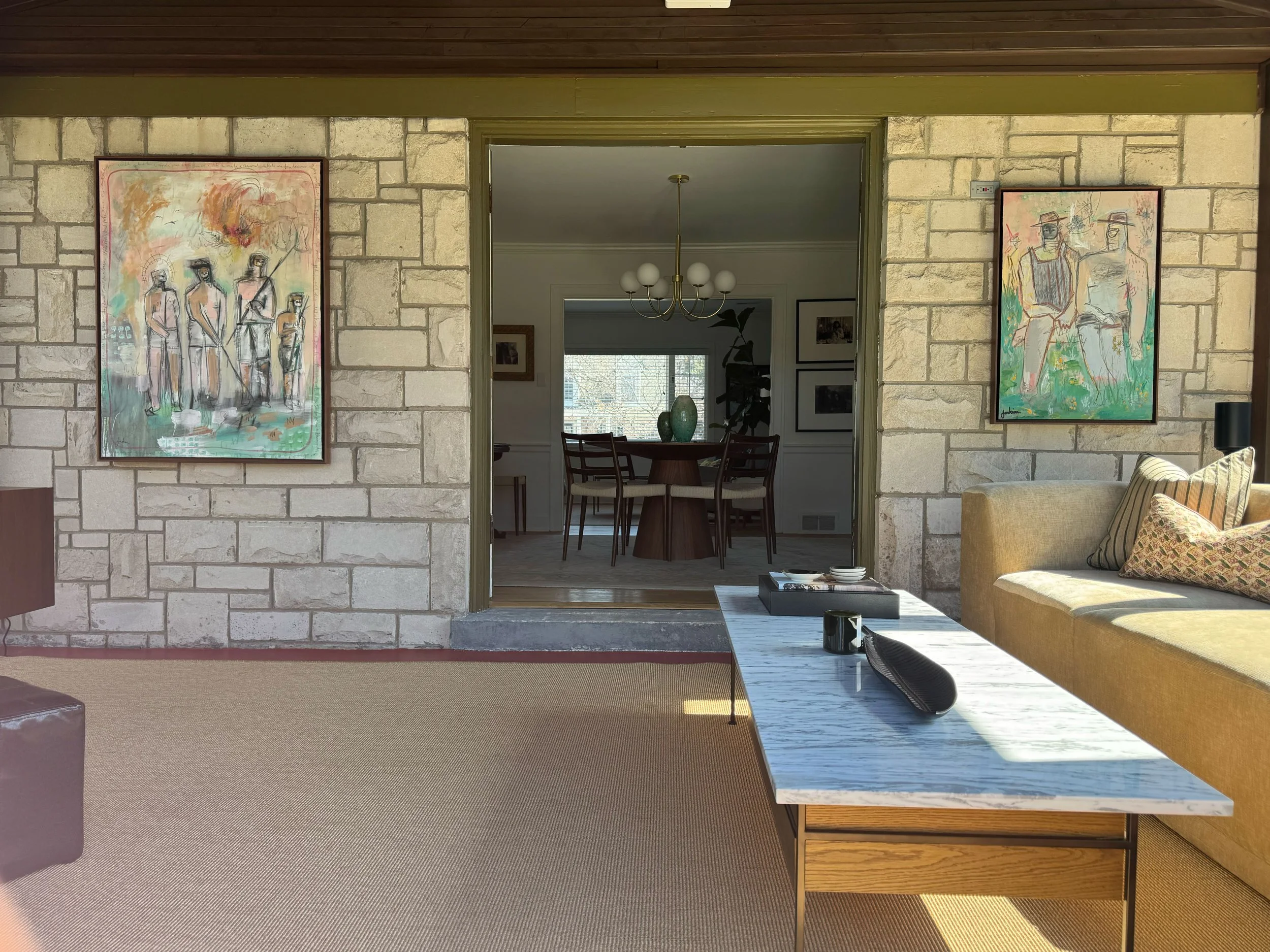 two expressive framed paintings by artist joshua jenkins hanging in collectors contemporary home.