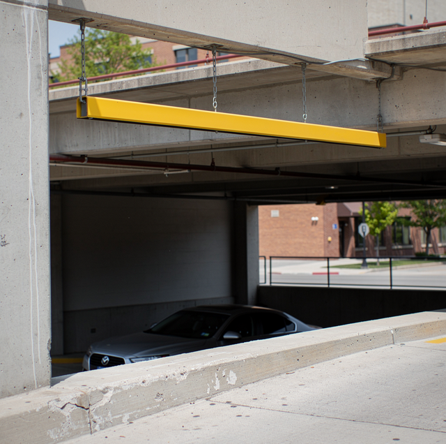 car parked nose-in against concrete wall underground garage