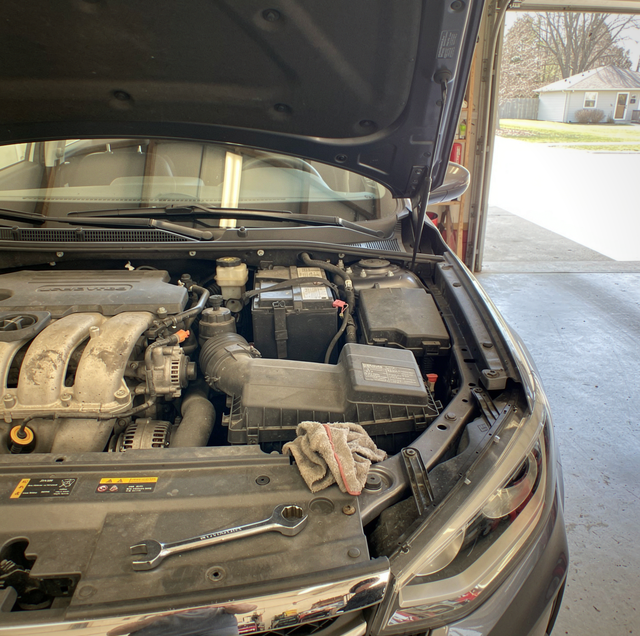 Blown engine car parked with hood open