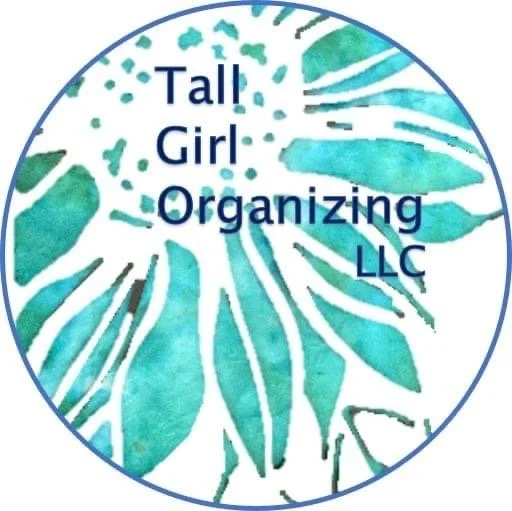 Logo for Tall Girl Organizing LLC featuring a teal-colored monstera leaf design with the company name in dark blue text.