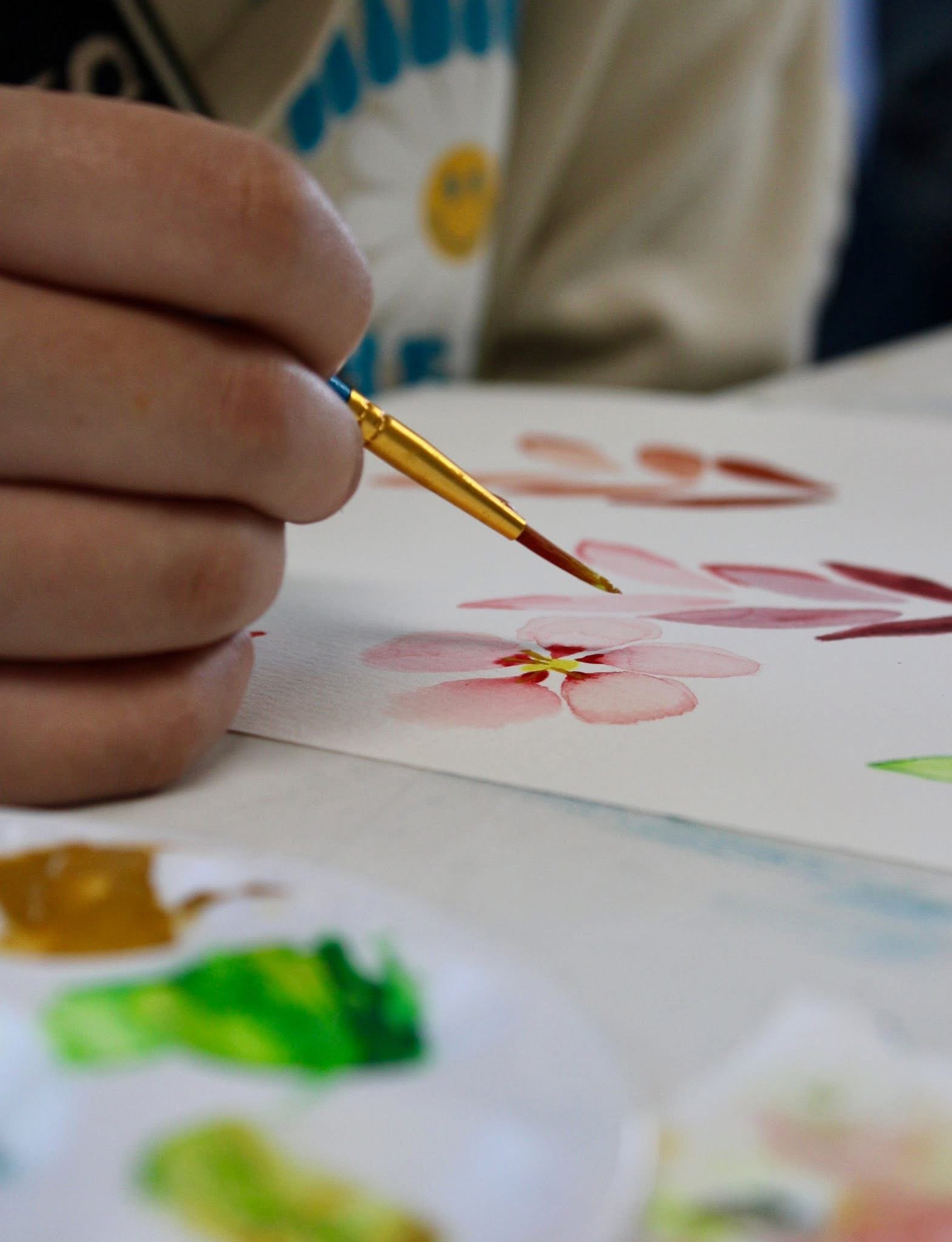 Close-up of watercolor painting in progress during a creative art activity highlighting process based art techniques used in private art parties for small groups of adults.
