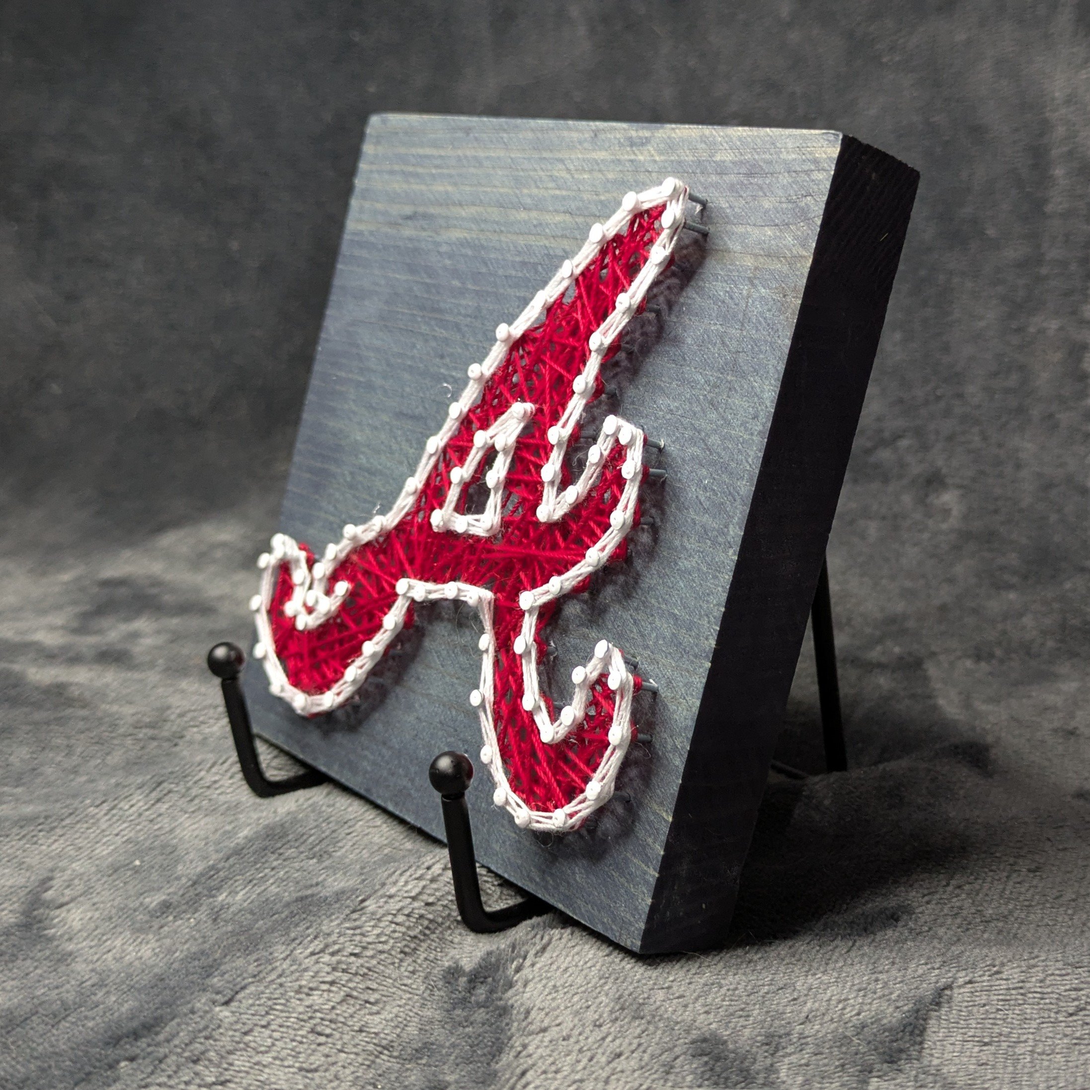 Atlanta Braves Logo Red with White Border on a Blue Board