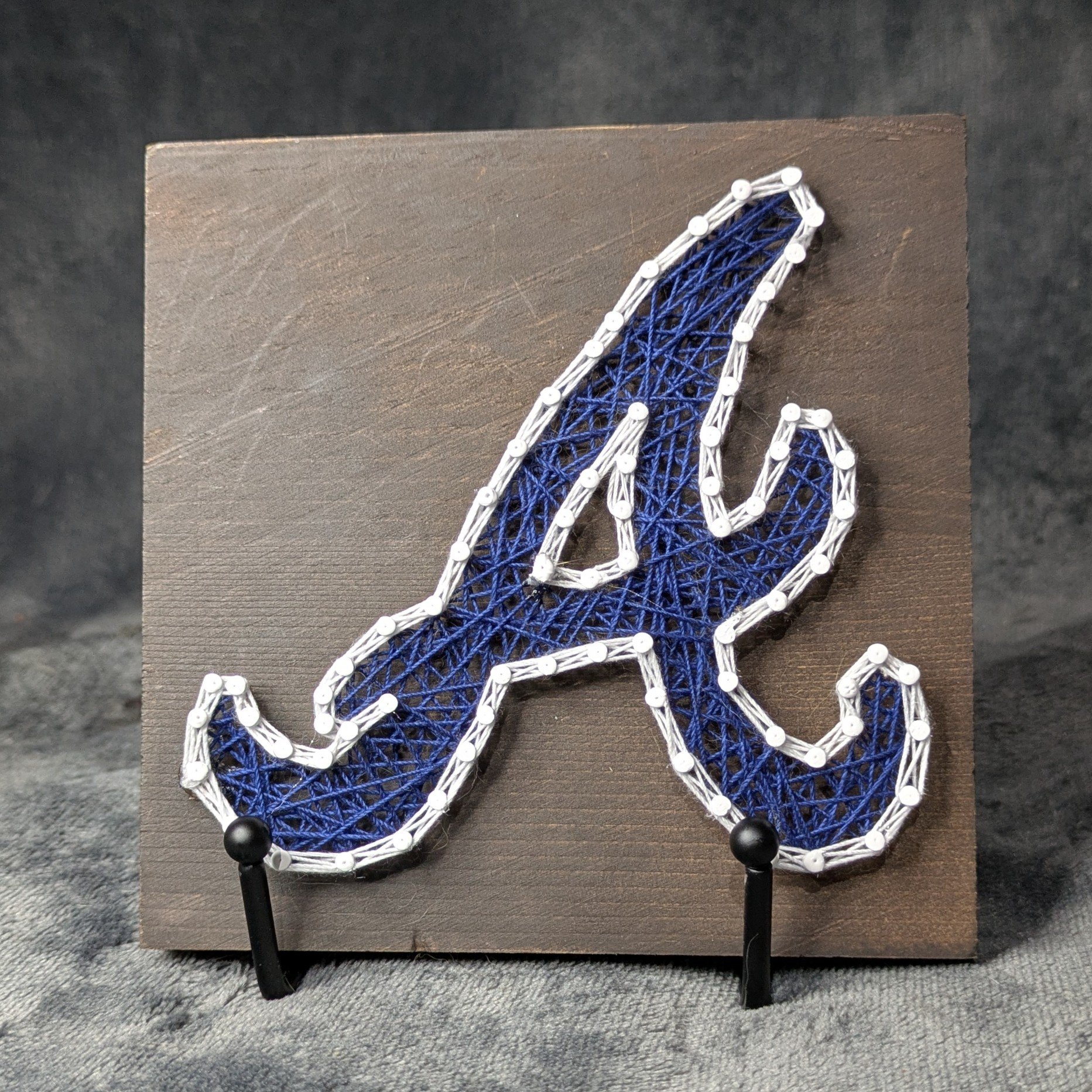 Atlanta Braves Logo Blue with White Border on a Dark Board