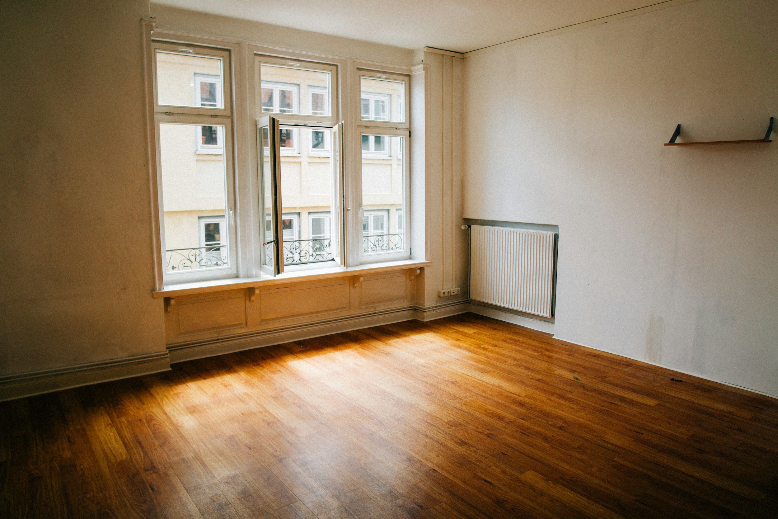 Empty room with moving boxes symbolizing ambiguous loss and grief after relocation