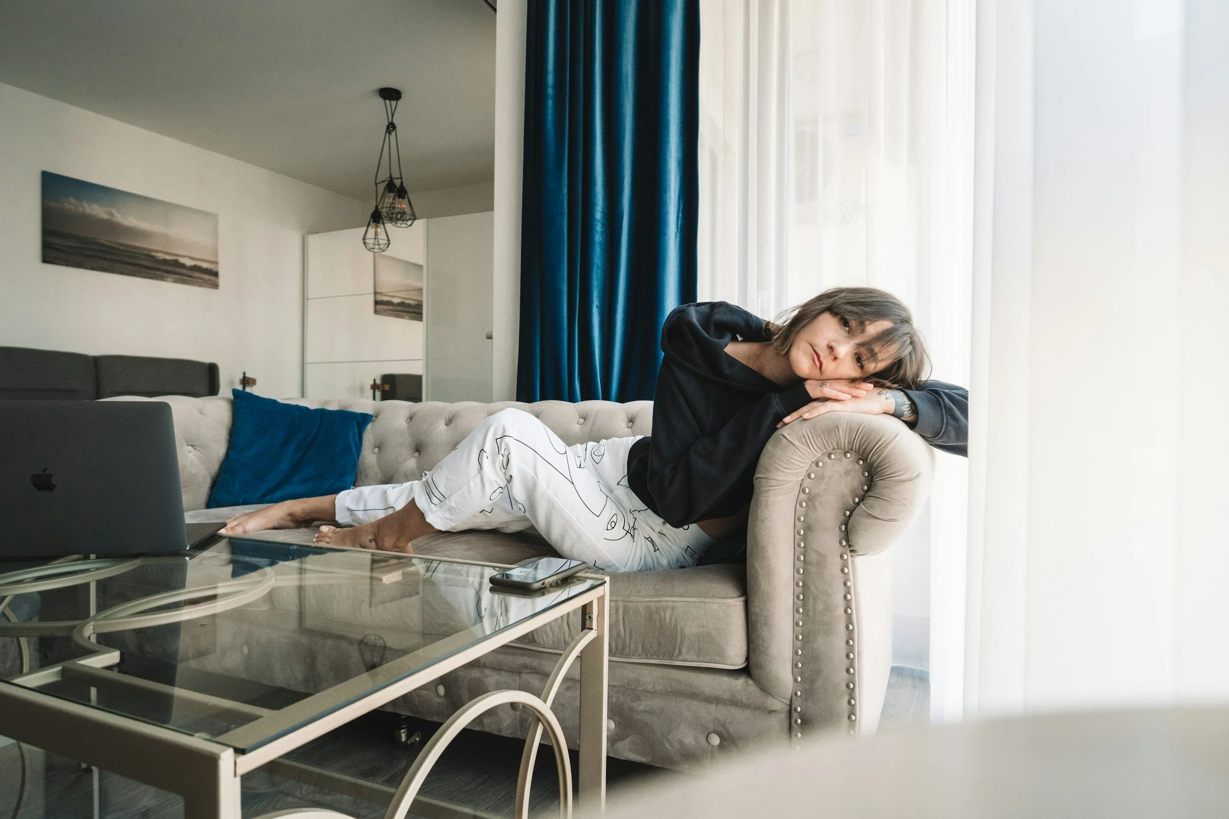 Woman sitting on couch Sunday evening dreading the work week representing burnout and work anxiety in Little Rock Arkansas