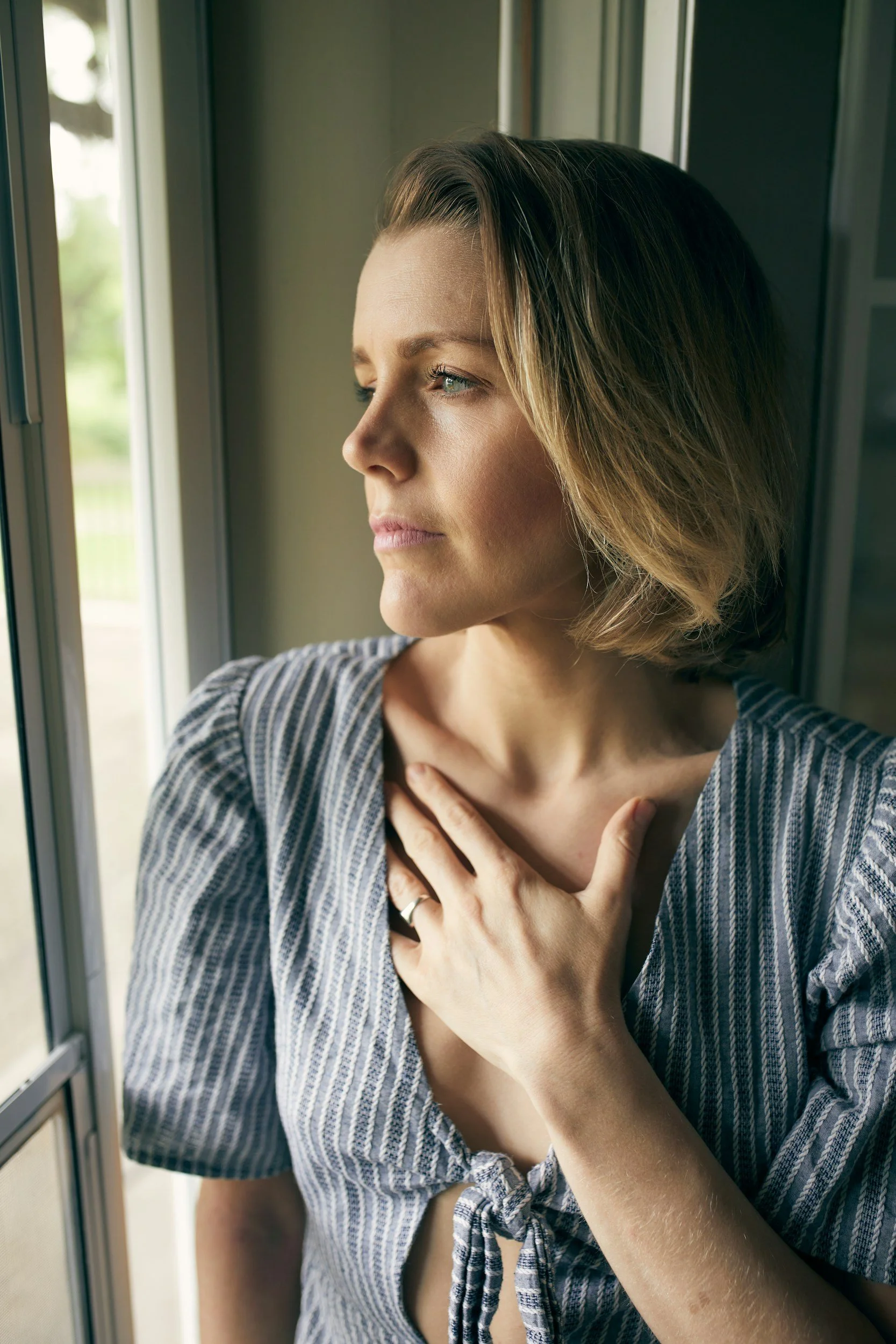 Exhausted woman sitting quietly representing burnout and the need for women's therapy in Little Rock Arkansas