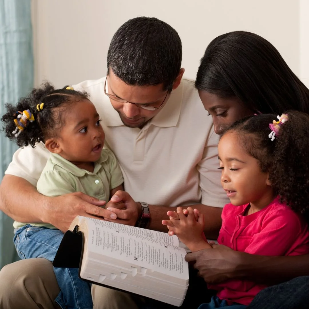 Christian family praying together representing spiritually healthy child raising in Little Rock Arkansas