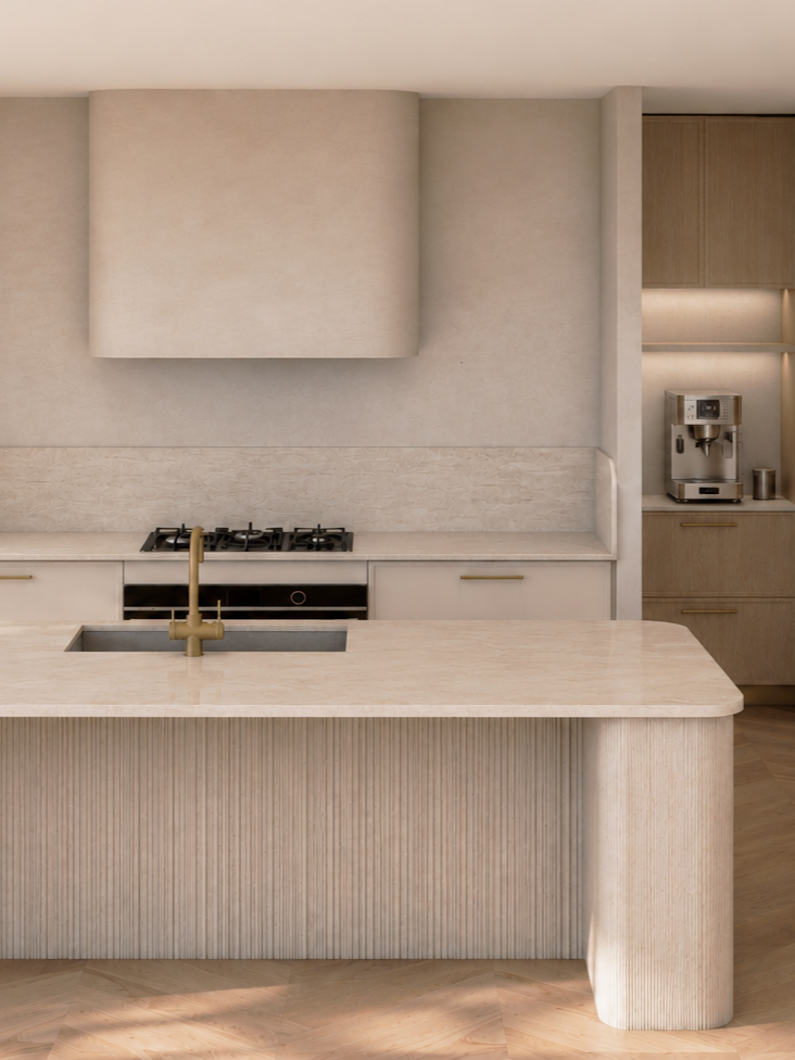 Modern kitchen with beige cabinetry, a built-in stove, and a kitchen island with a beige countertop and gold faucet. A coffee machine is on the right side on a wooden cabinet.