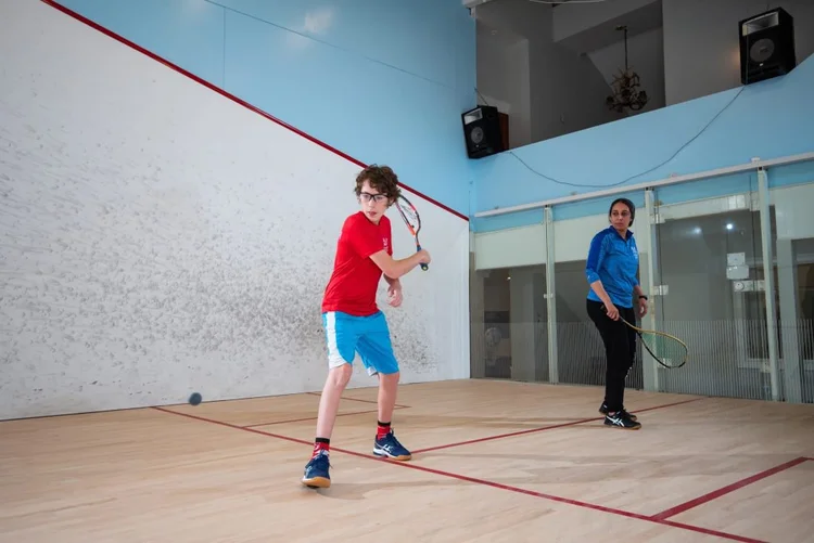 Junior squash instruction on court at Monmouth