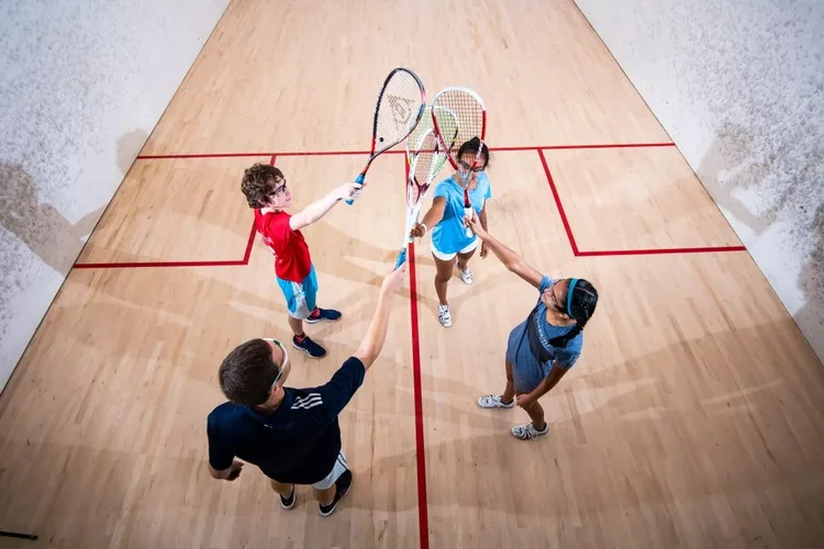 Junior squash players bringing their racquets together at Monmouth