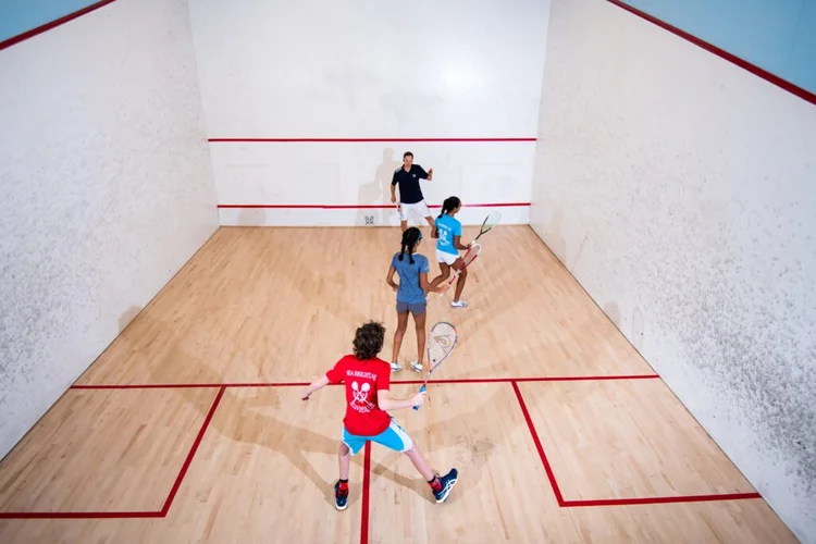 Juniors learning squash together on a Monmouth court