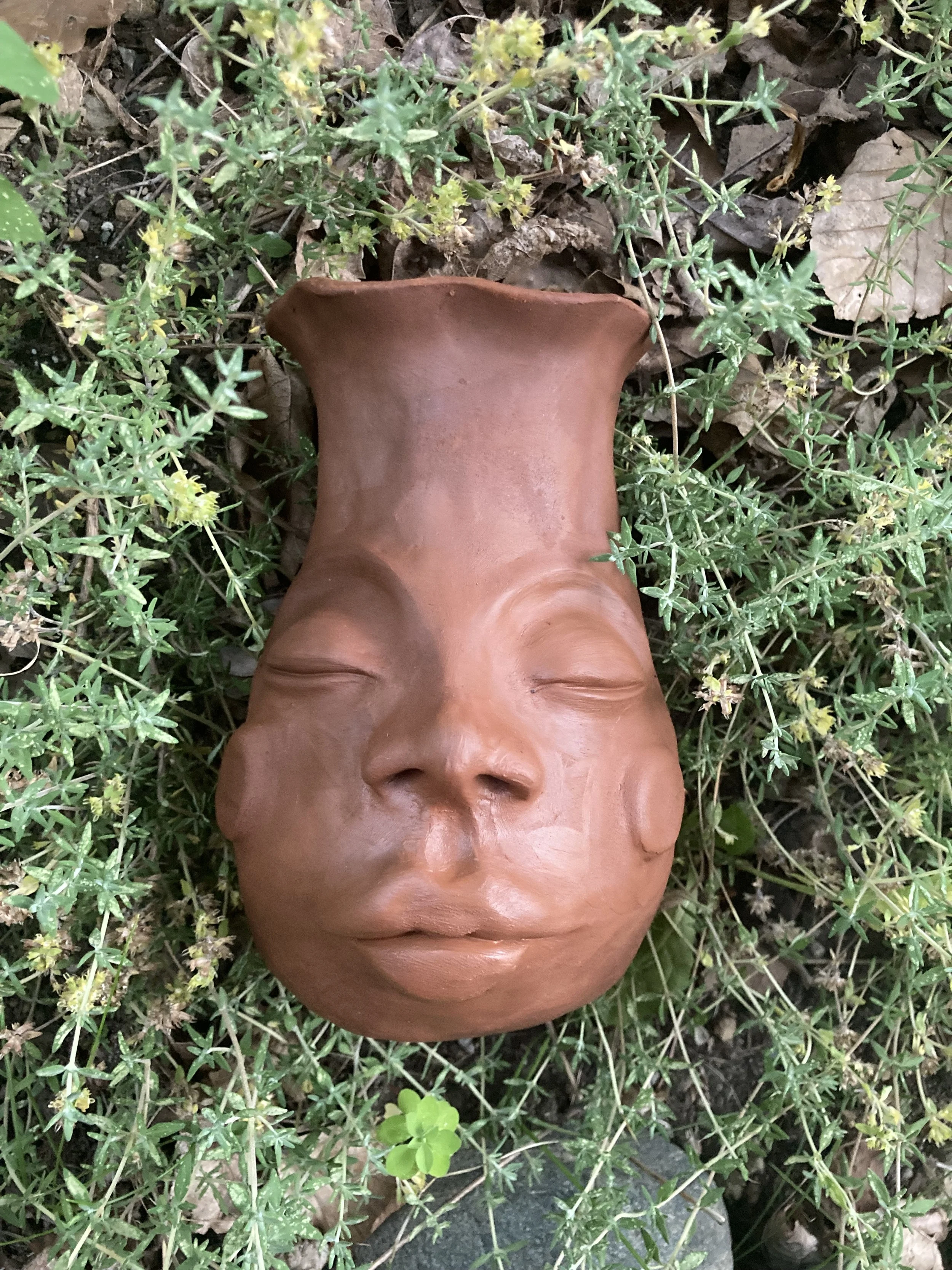Handbuilt clay face vessel sculpted by Alexandria Thompson as part of a creative embodiment practice exploring rest, identity, and earth-based connection