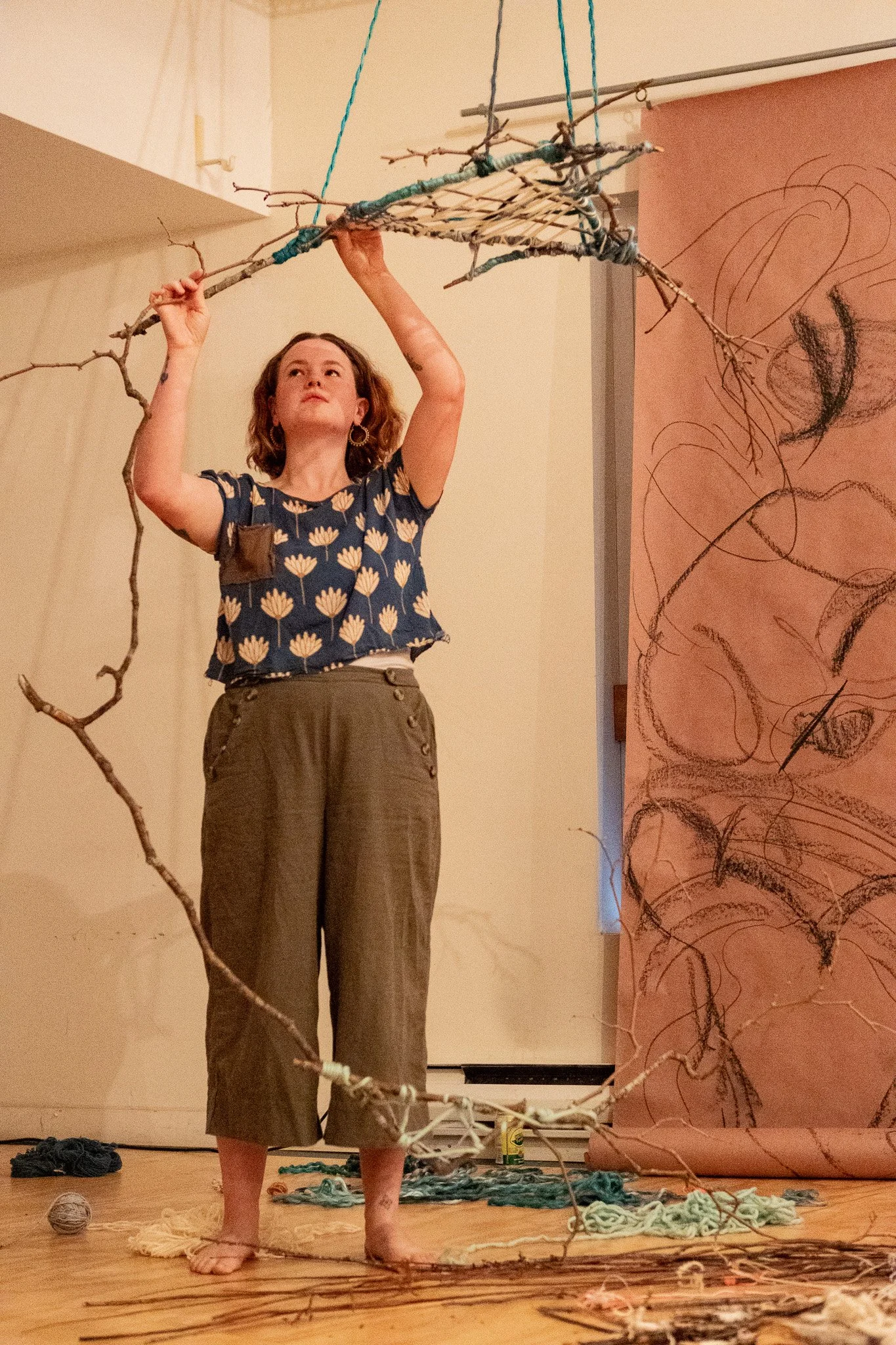 Artist and facilitator, Alexandria Thompson, engaging in Portals, a community eco-art project using found natural materials and weaving to explore connection and place