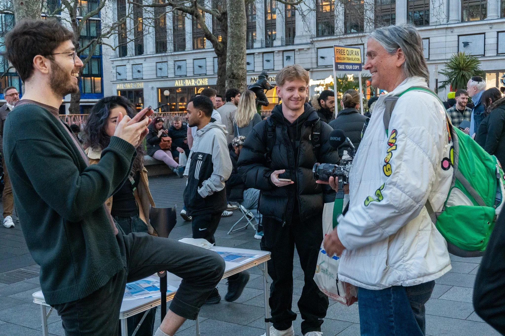 Jack is smiling, whilst doing animal rights street activism with friends