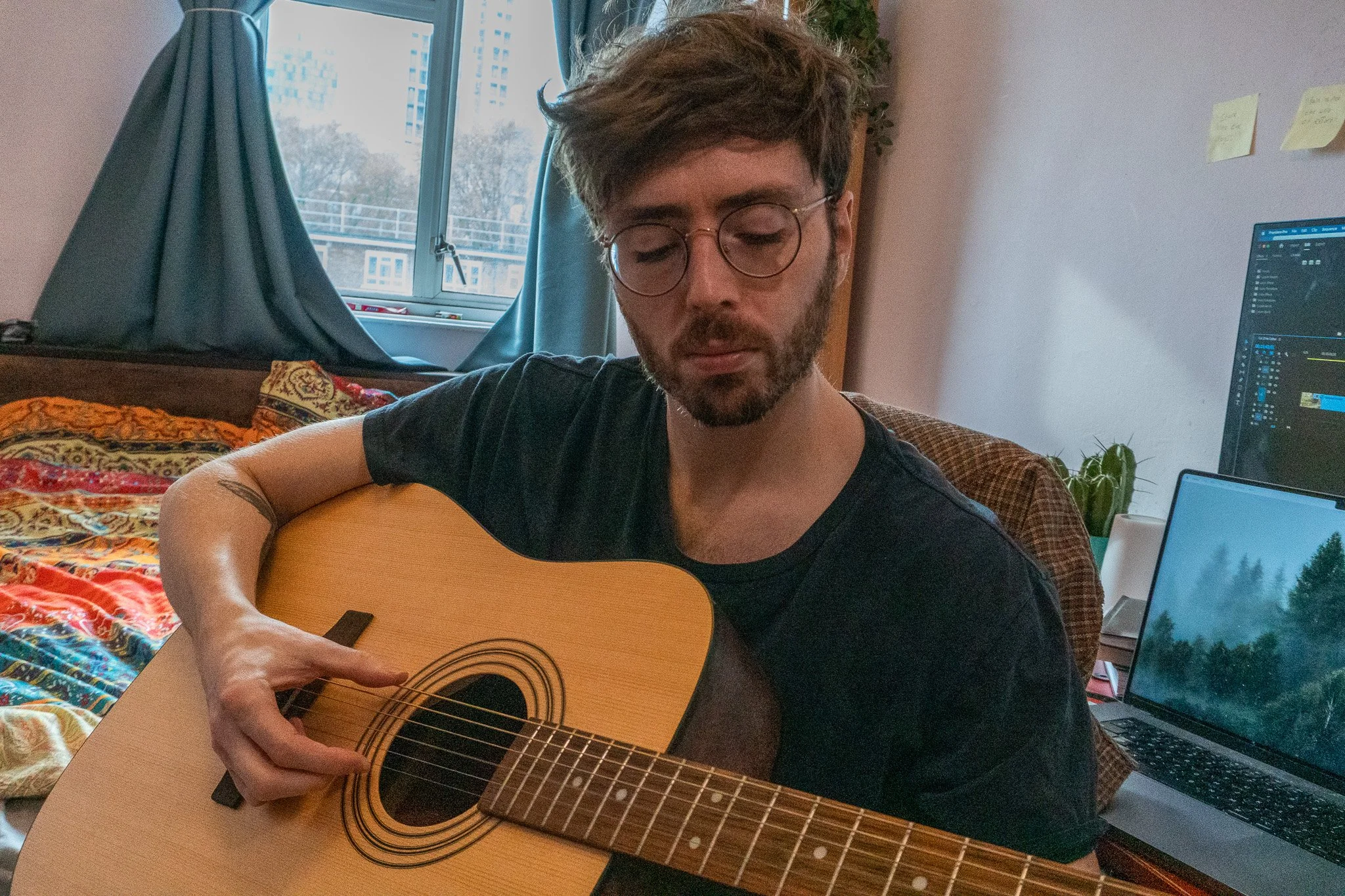 Jack is playing a guitar in his room