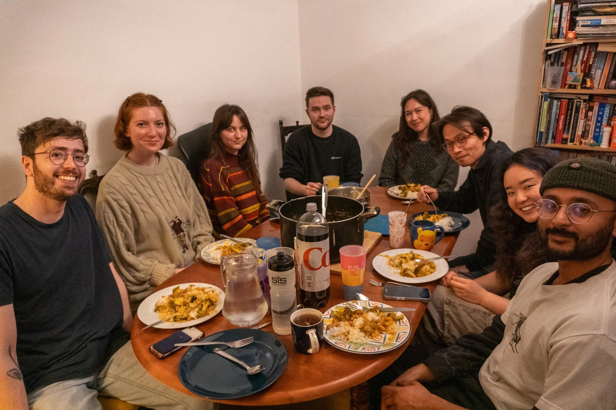 Jack is smiling and having dinner with seven people, who just gave feedback about his documentary.