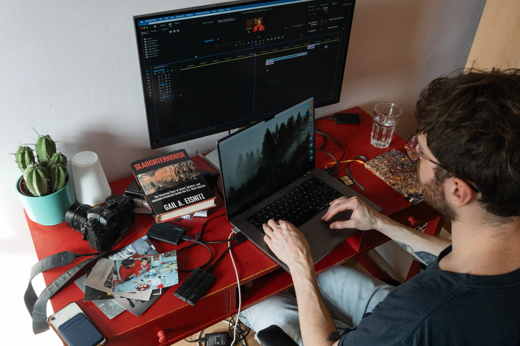 View from above. Jack is sitting at his desk and editing his documentary.