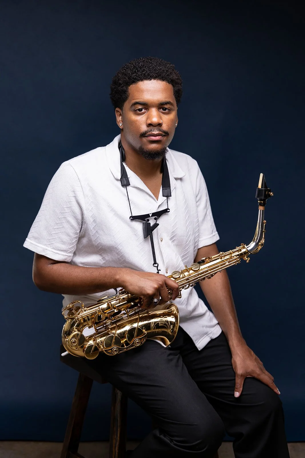 Chris Powe holding saxophone