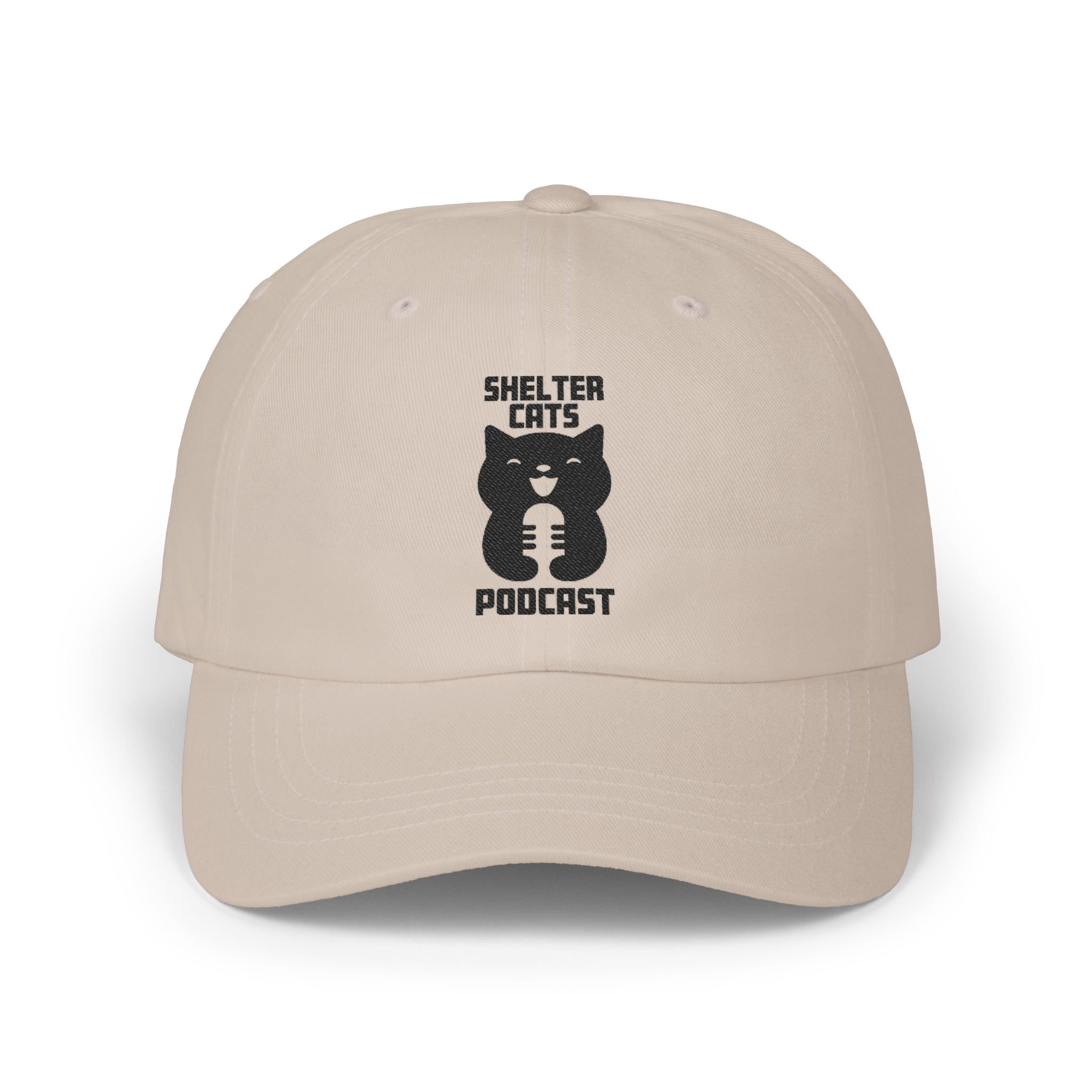 Beige baseball cap with 'Shelter Cats Podcast' logo featuring a black cat holding a microphone