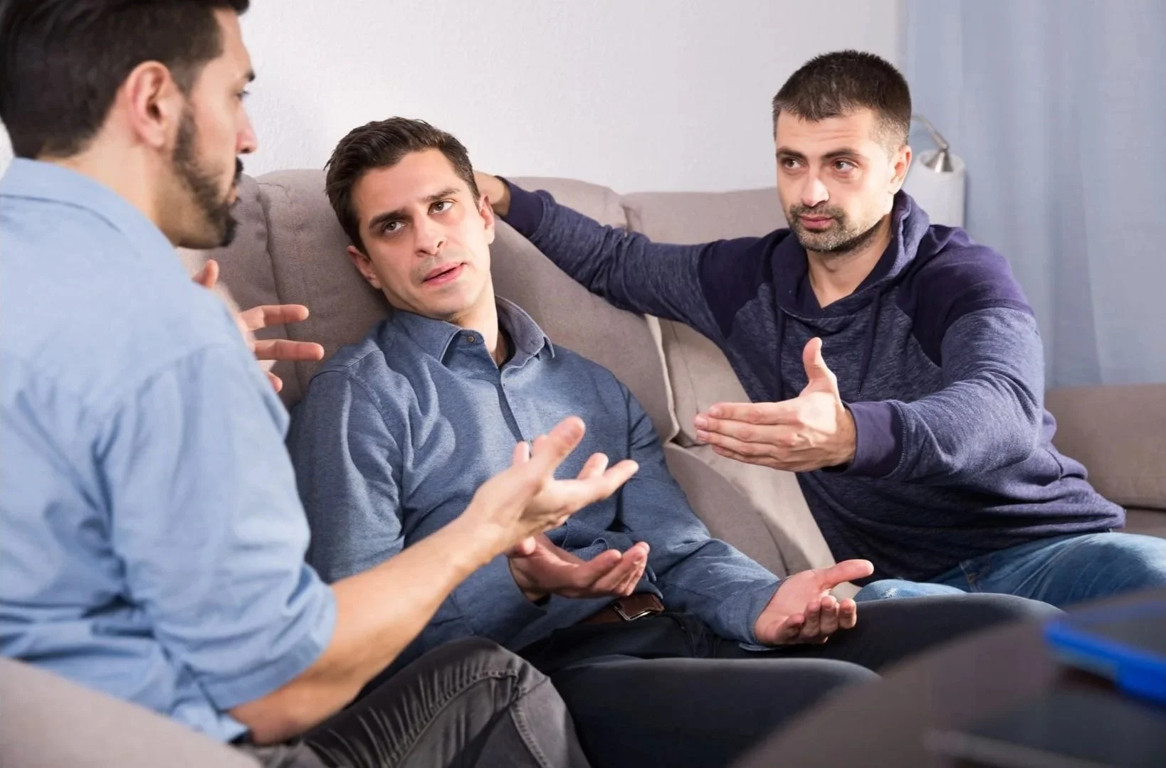 Couple discussing dog training approach during session with trainer