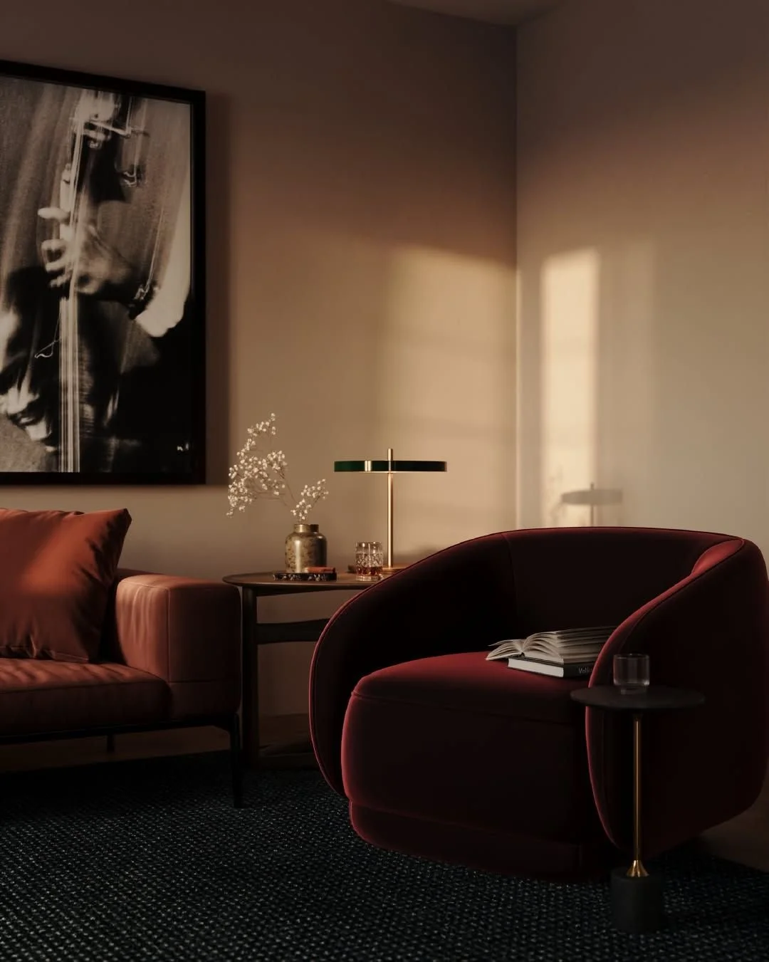 A cozy corner of a living room with a velvet armchair, a side table, a framed black-and-white photograph, and decorative items, illuminated by warm, natural sunlight.