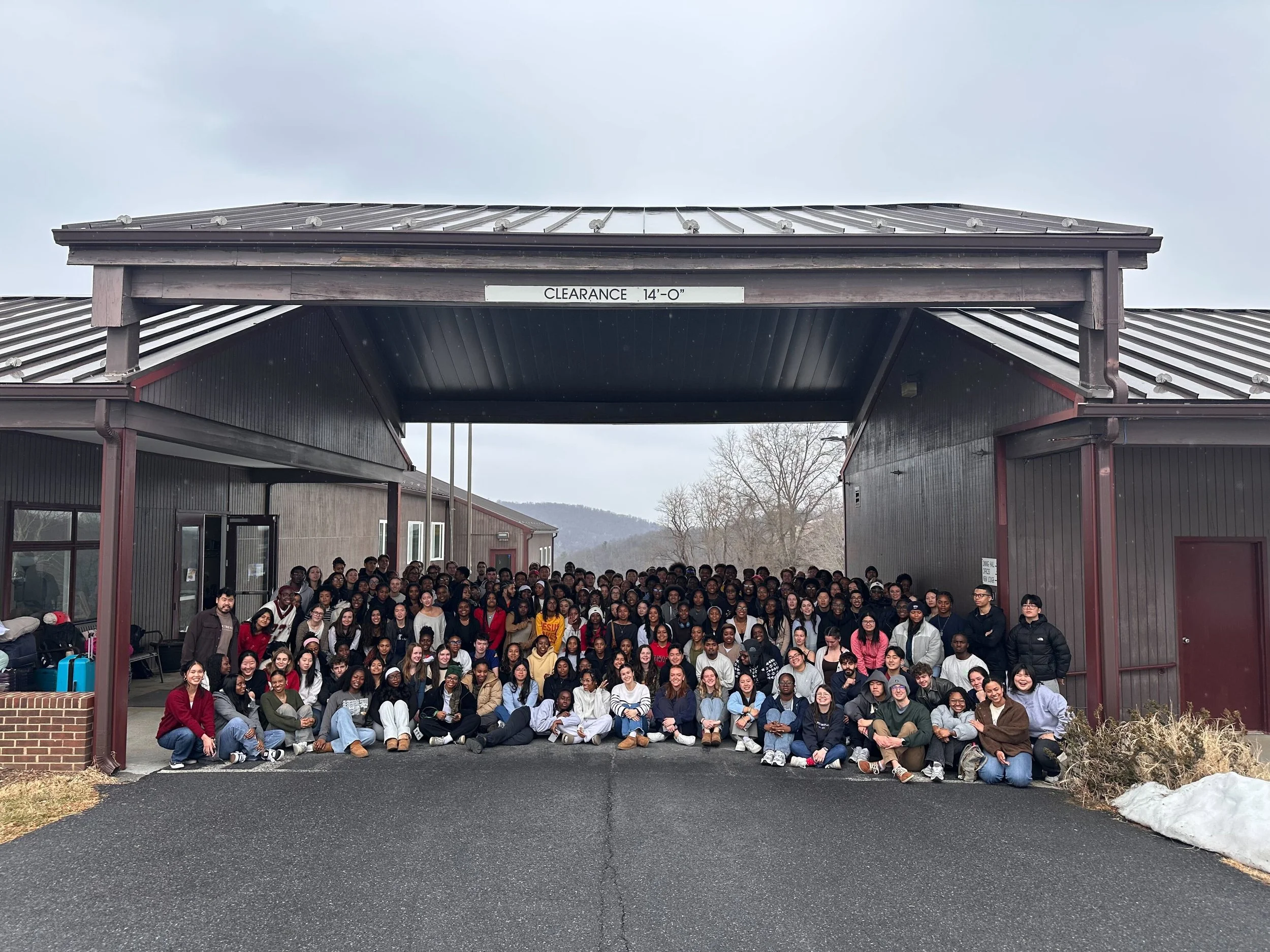 Large group of people smiling outdoors.