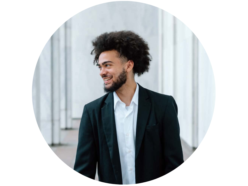 Smiling man in a suit with a white background..