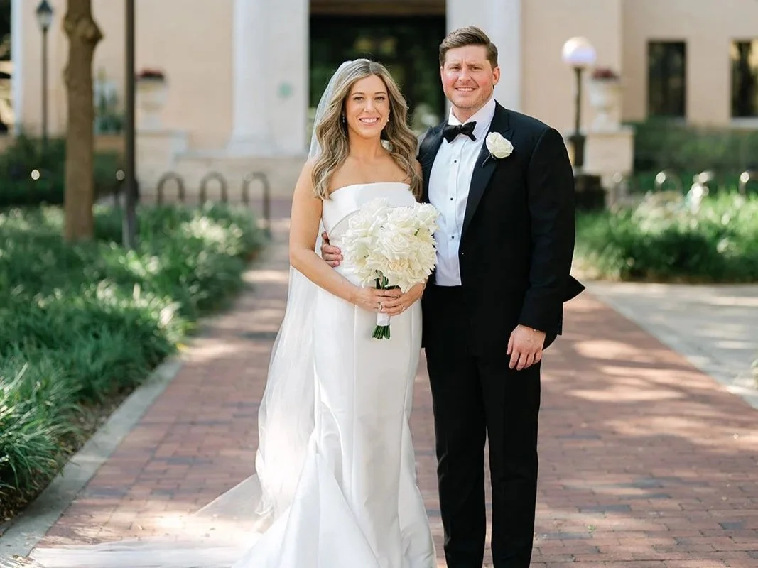 Emerald Gardenia bride and groom wedding portrait with bouquet in hand.