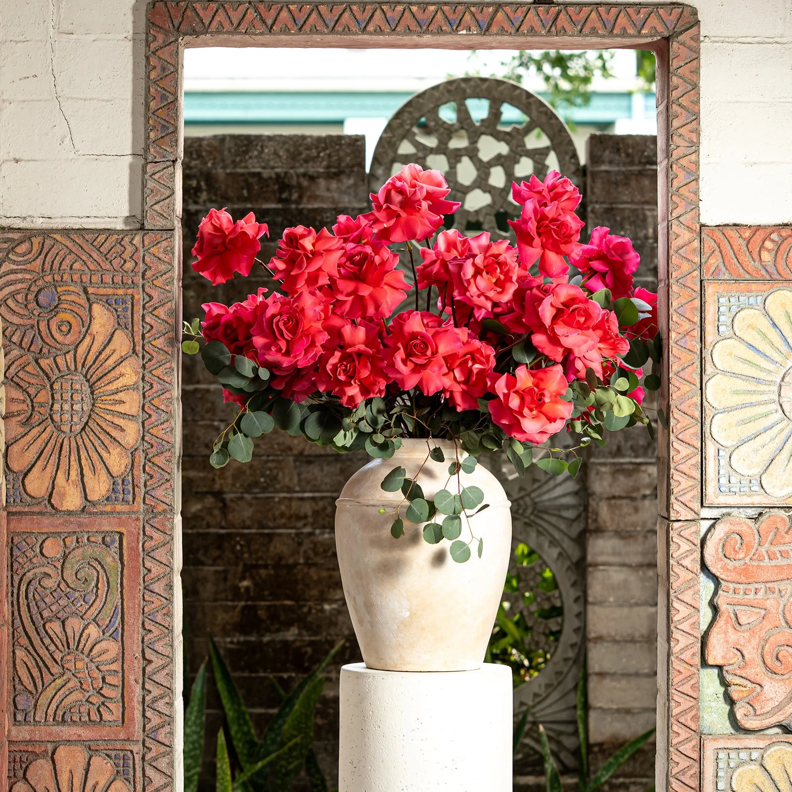 50 reflexed roses arranged in a full, elegant floral composition with soft open blooms