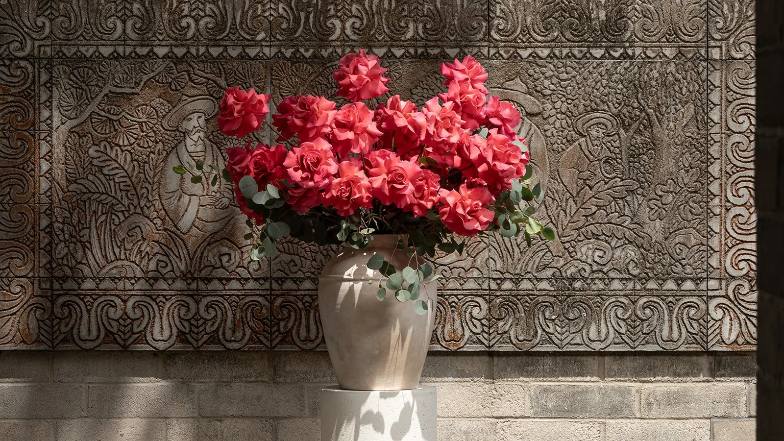 50 reflexed roses arranged in a full, elegant floral composition with soft open blooms