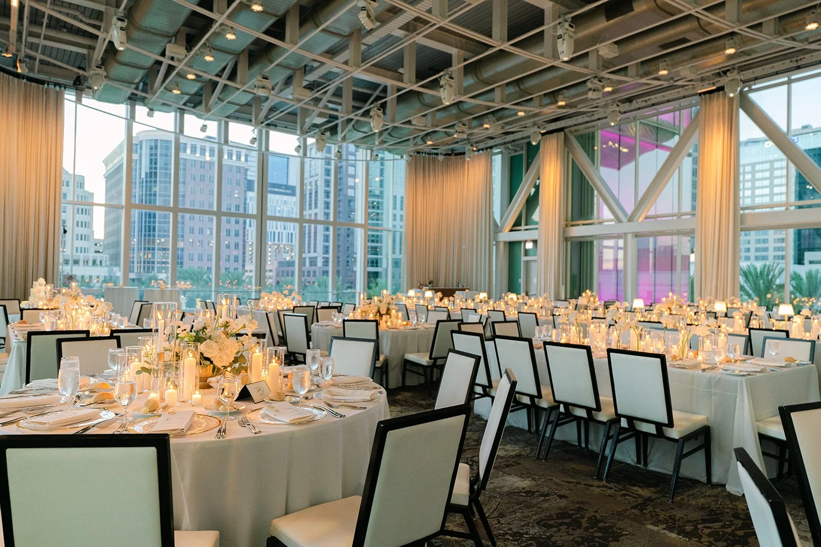 Emerald Gardenia luxury dining table setup with floral decor, candles, and elegant white linen.