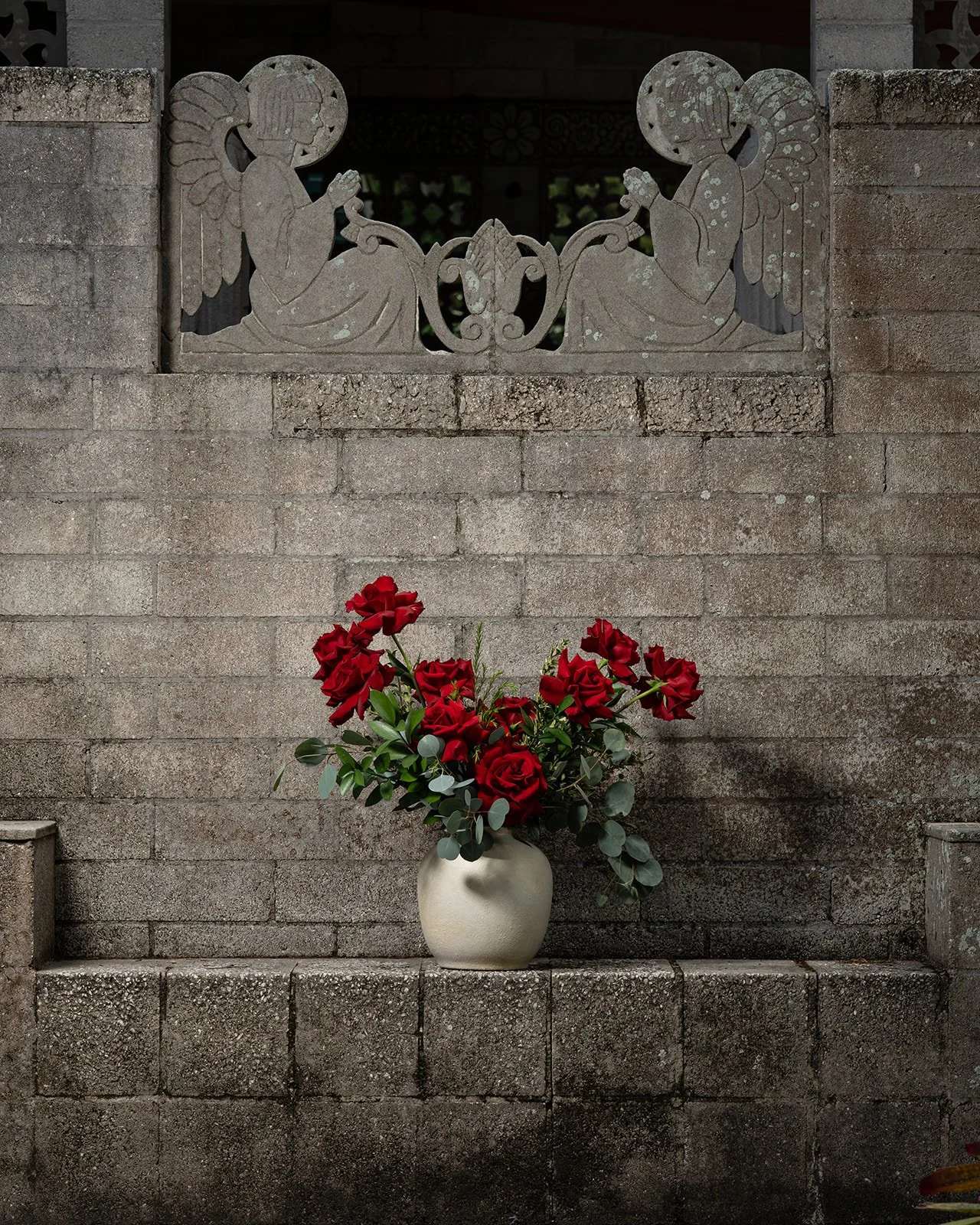 Dozen reflexed rose arrangement with open blooms styled in a classic, elegant floral design