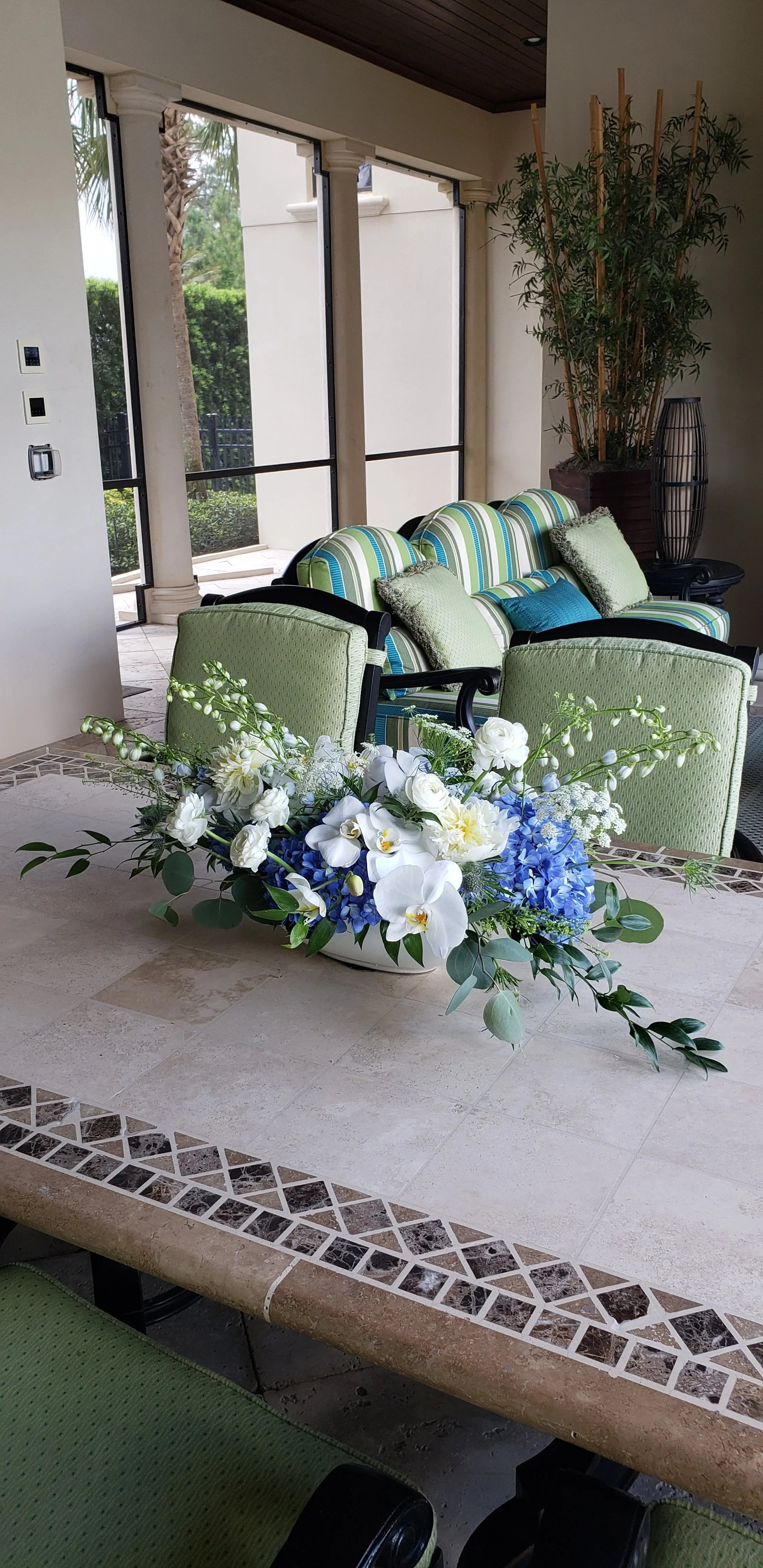 Soft blue and white floral arrangement with airy seasonal blooms designed to feel light, serene, and elegant