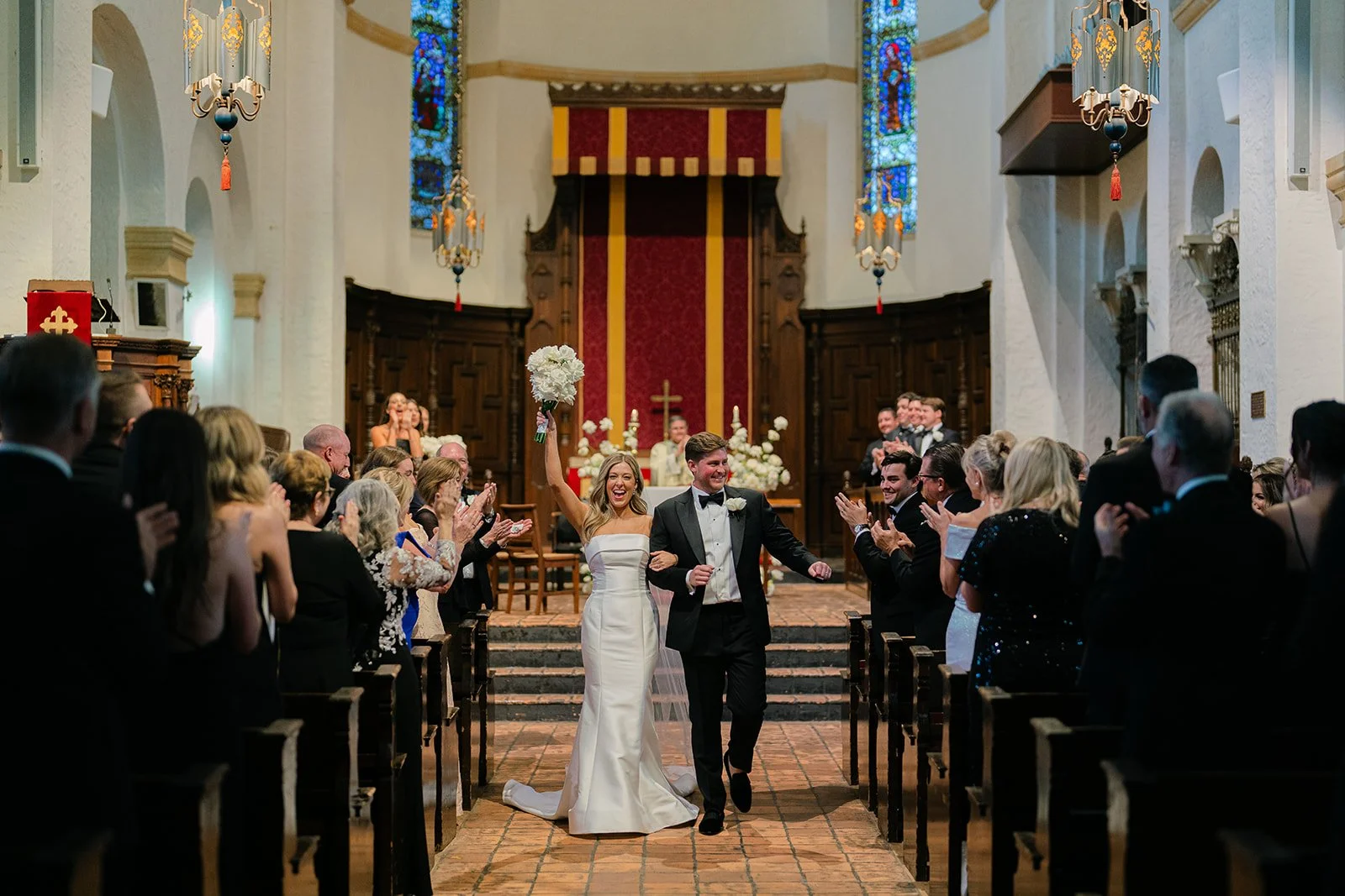 Emerald Gardenia wedding floral arrangements as bride and groom walk down the aisle.