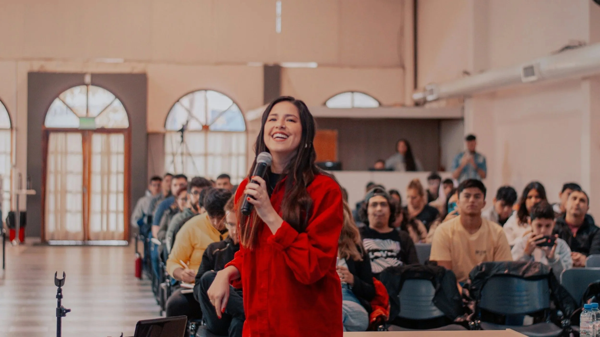Young woman performing on stage before a crowd in St. Louis.